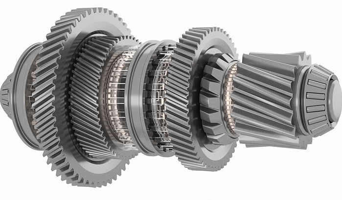 Close-up of a multi-gear mechanical transmission component with several interlocking gears of varying sizes.