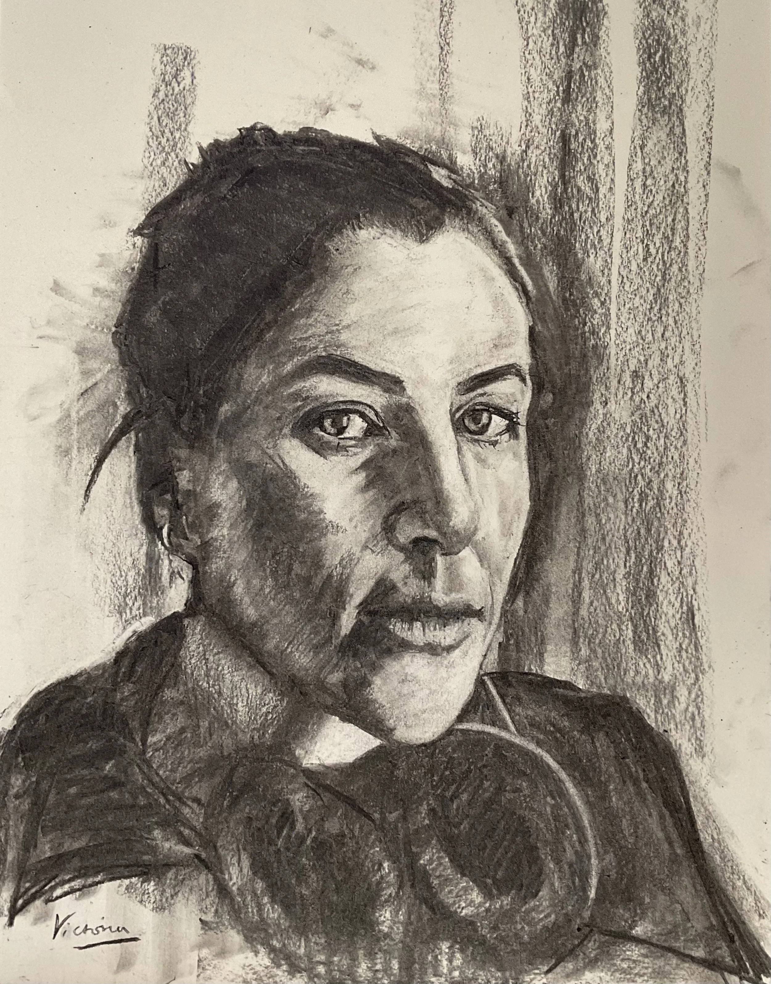 A black and white charcoal portrait sketch of a woman with dark hair, expressive eyes, and a serious expression, labeled 'Victoria' in the bottom left corner.