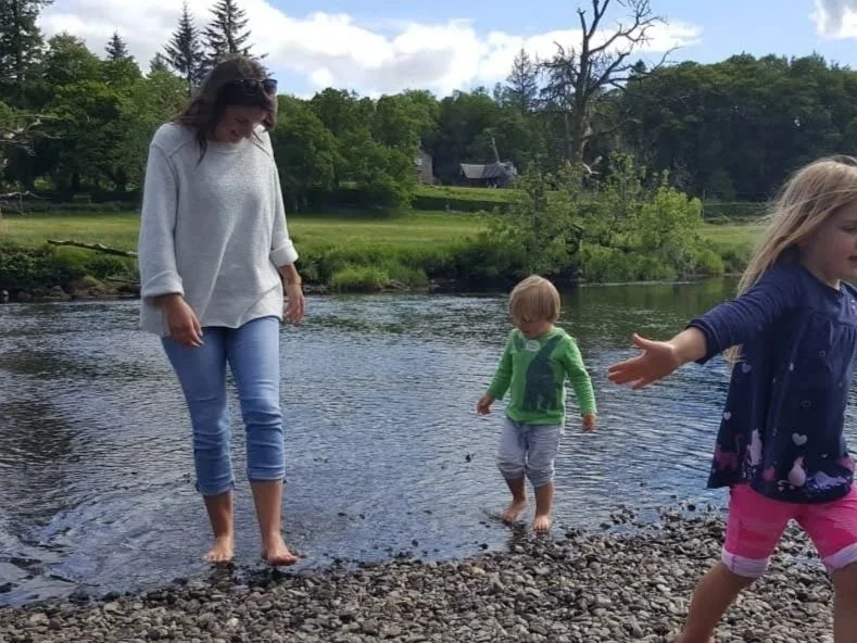 Erin with family paddling in a Scottish river — family and slow living in Scotland