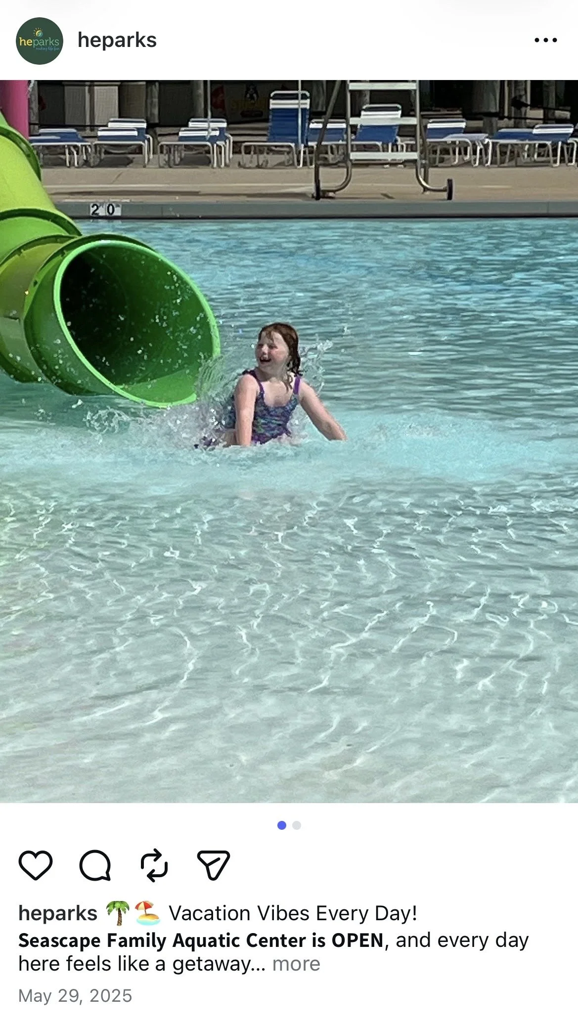 girl in pool next to tube slide