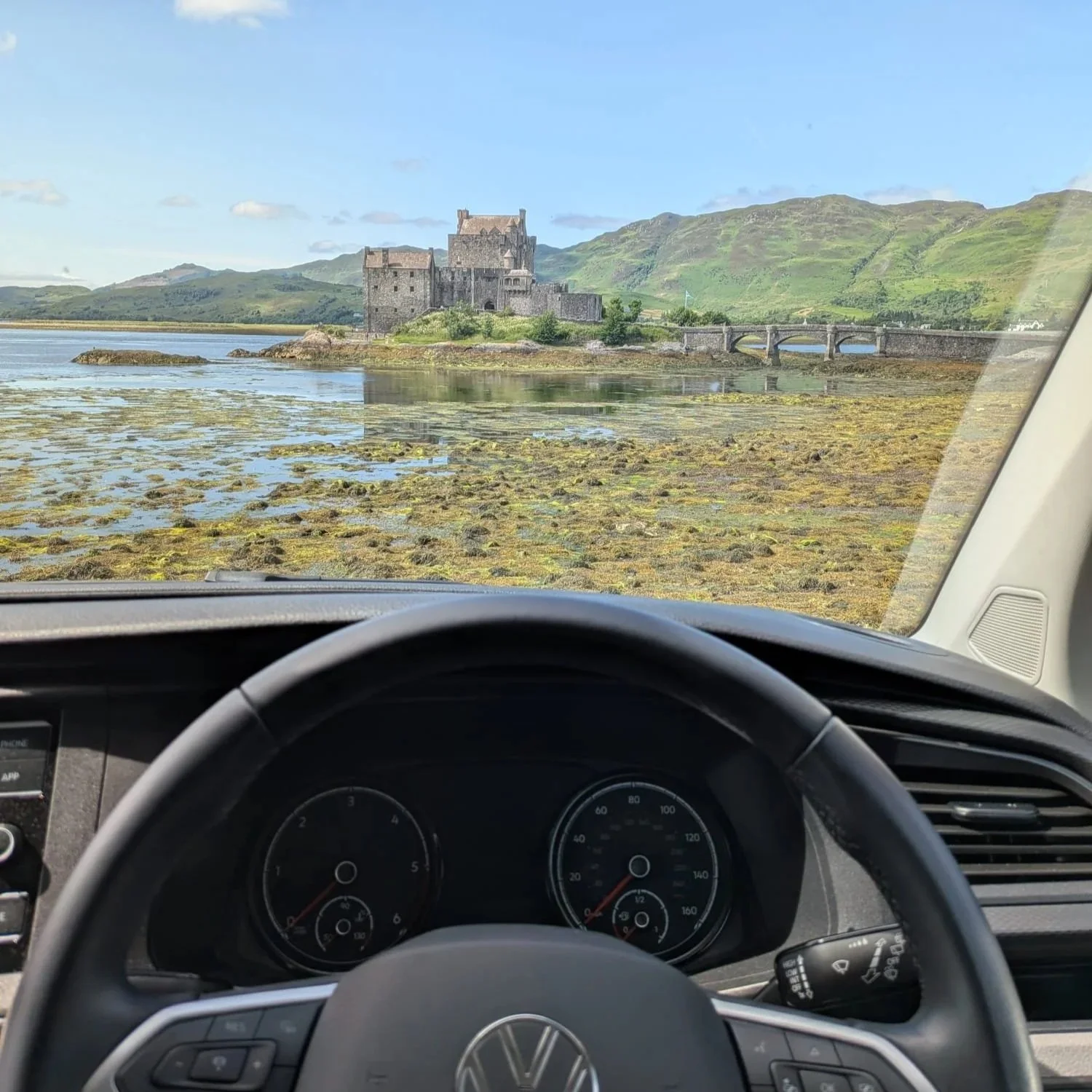 The view from a Volkswagen T6.1 Transporter campervan through the windscreen showing Elaine Donan Castle, (the james bond castle)