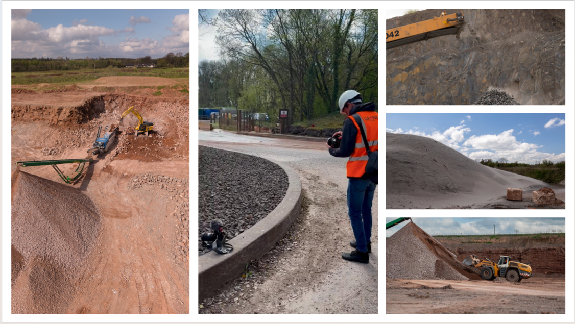 Construction site with excavators and vehicles working on dirt and gravel, a worker with a helmet and safety vest, and a person with a camera near the road.