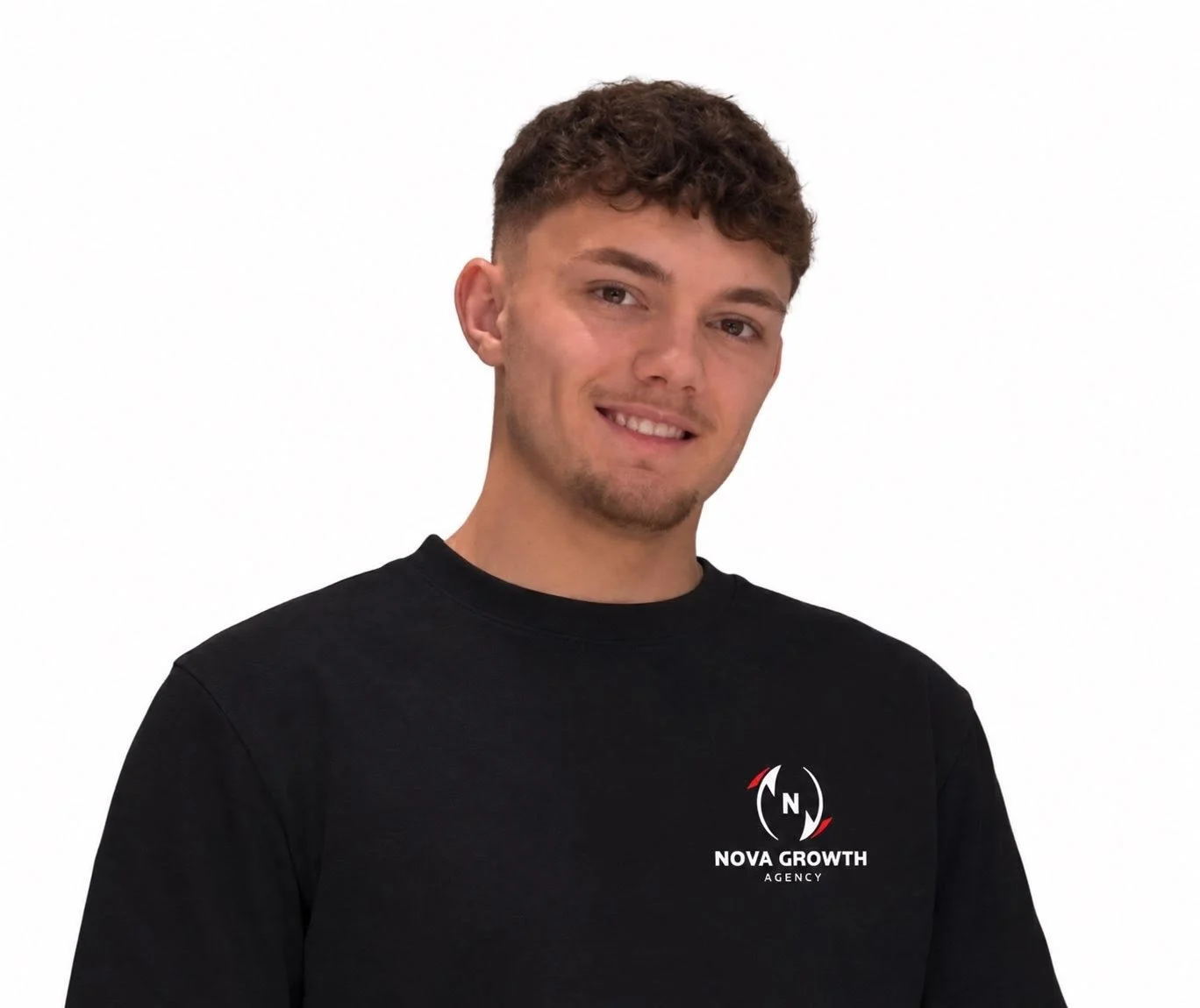 A young man with short curly hair and a goatee, smiling slightly, wearing a black t-shirt with 'NOVA GROWTH AGENCY' logo on the front, standing against a plain white background.