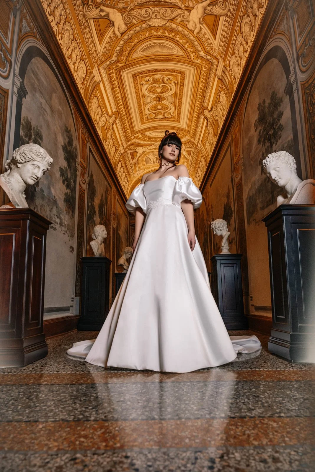 Bride standing inside ornate palace during luxury bridal fashion editorial