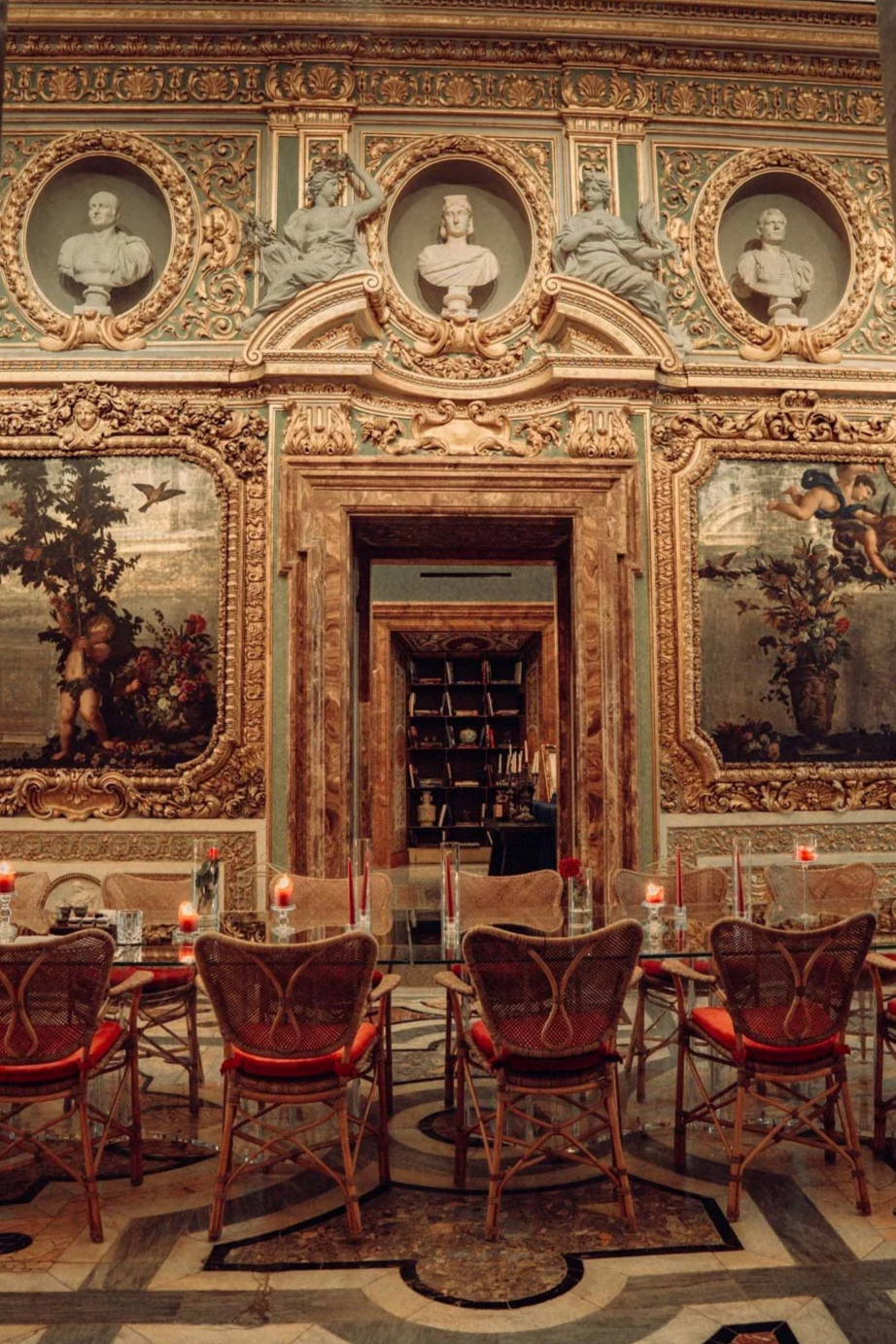 Elegant historic interior in Rome featuring classical architecture, warm candlelight, and cinematic editorial atmosphere.