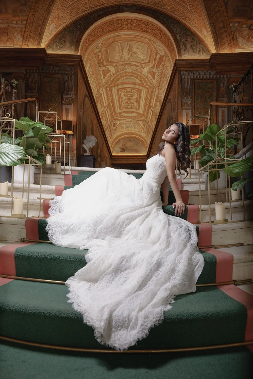 Bride posing with dramatic couture gown inside luxury wedding venue