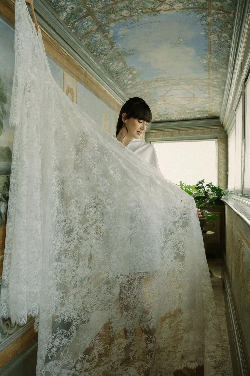 Bride wearing dramatic veil during fine art bridal editorial