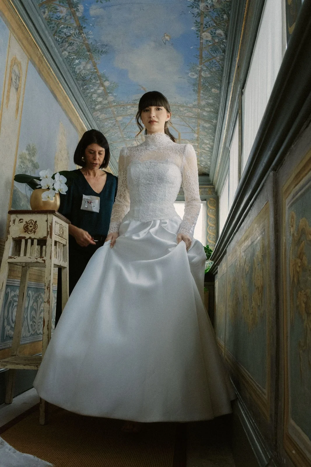 Bride walking through ornate Italian palace during luxury wedding editorial