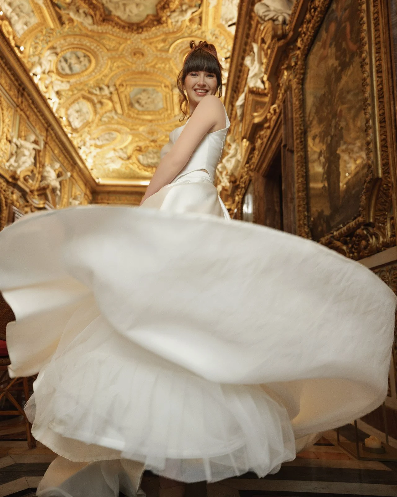 Bride wearing couture wedding dress inside historic palace during luxury bridal editorial experience