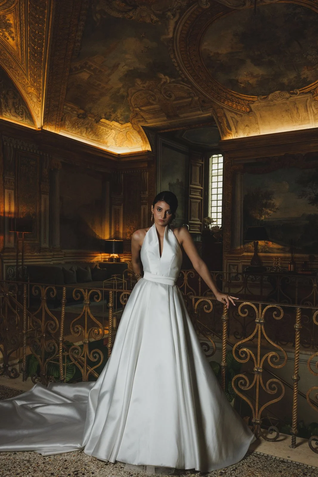 Moody bridal editorial portrait inside luxury historic venue