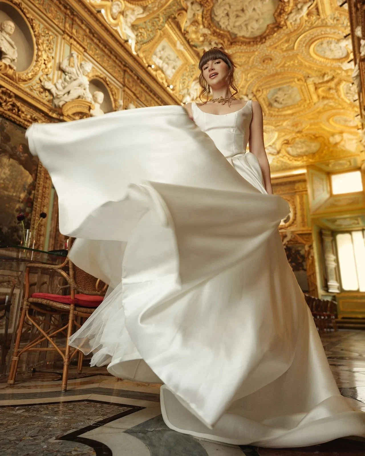 Bride wearing couture wedding dress inside ornate palace during luxury bridal editorial in Rome