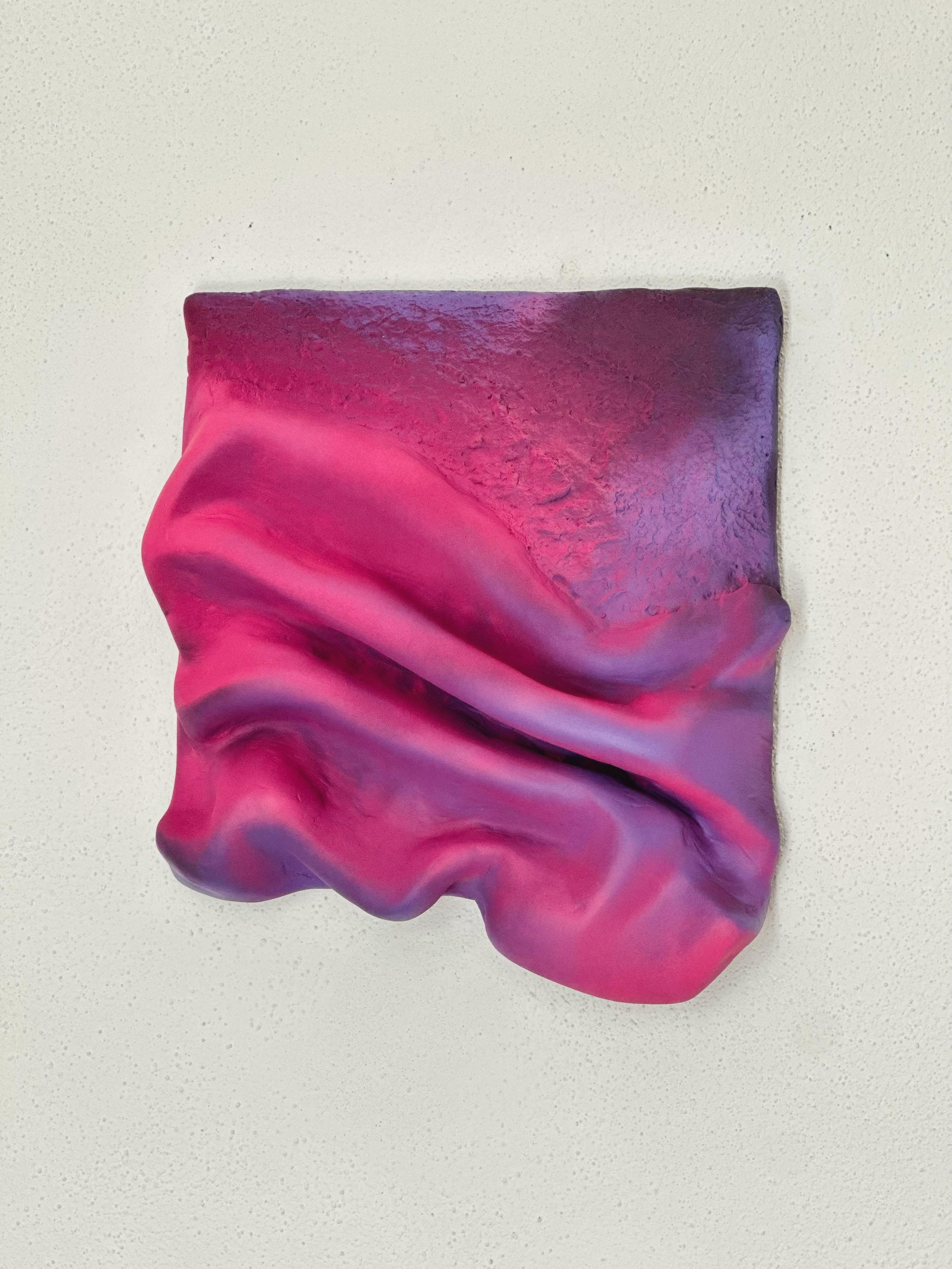 Close-up of abstract textured ceramic sculpture in pink and purple tones
