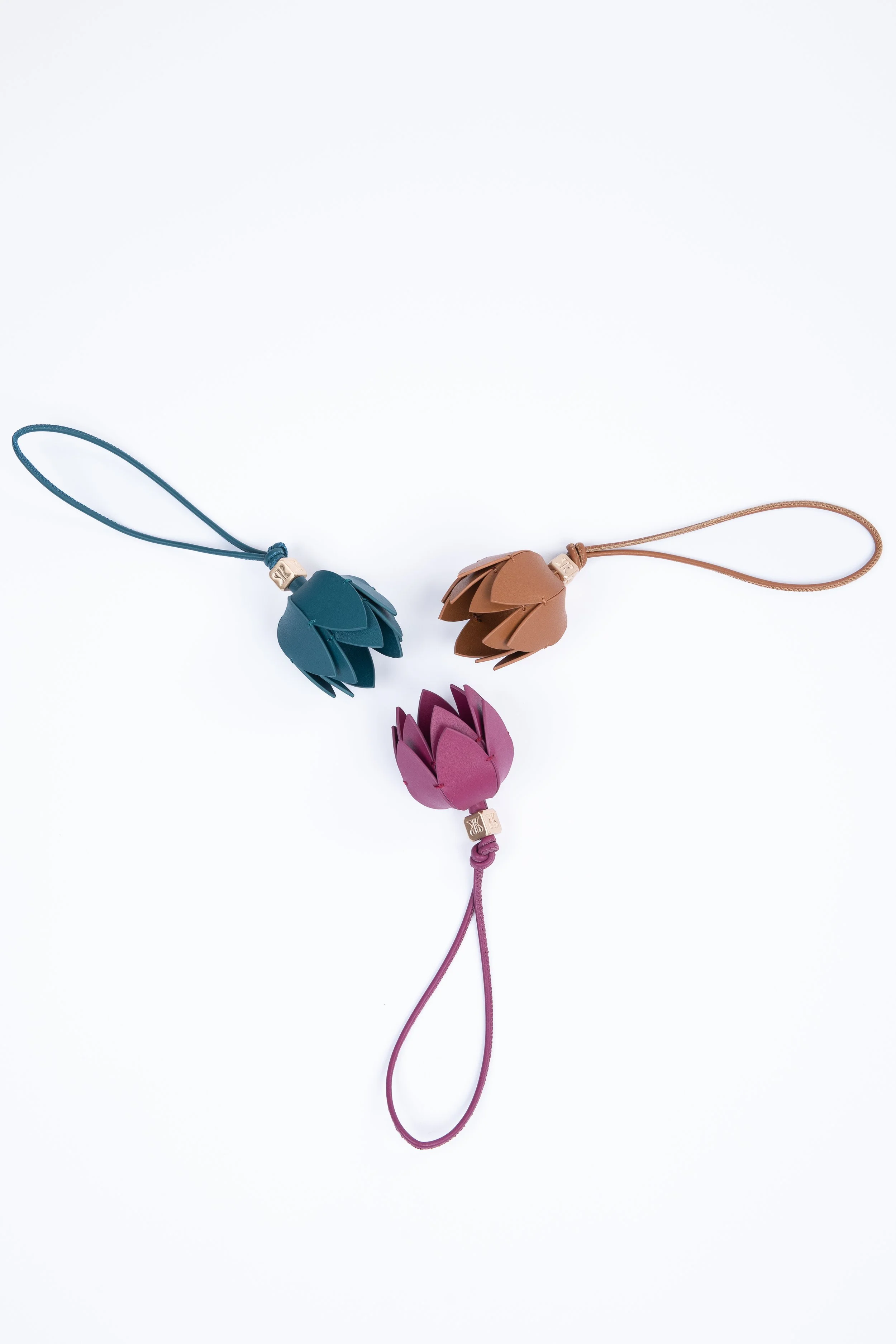 Accessorize your RACKED Mahjong tote with these handmade leather bag charms for the perfect additional detail on any bag. Inspired by the Lotus flower.