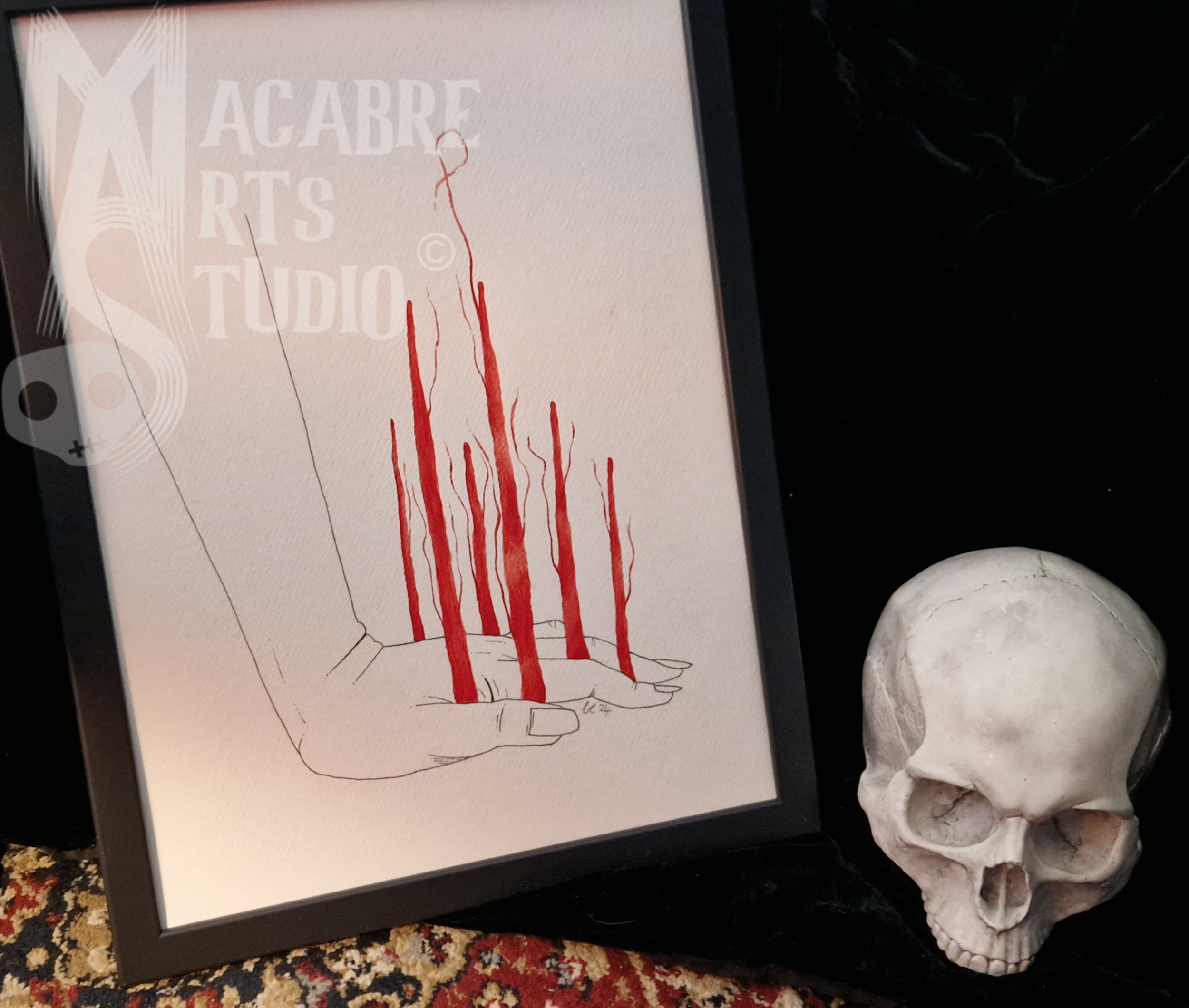 Image of a drawing showing a hand holding a bone with red lines representing blood flow, and a partially visible skull on the right side of the image.