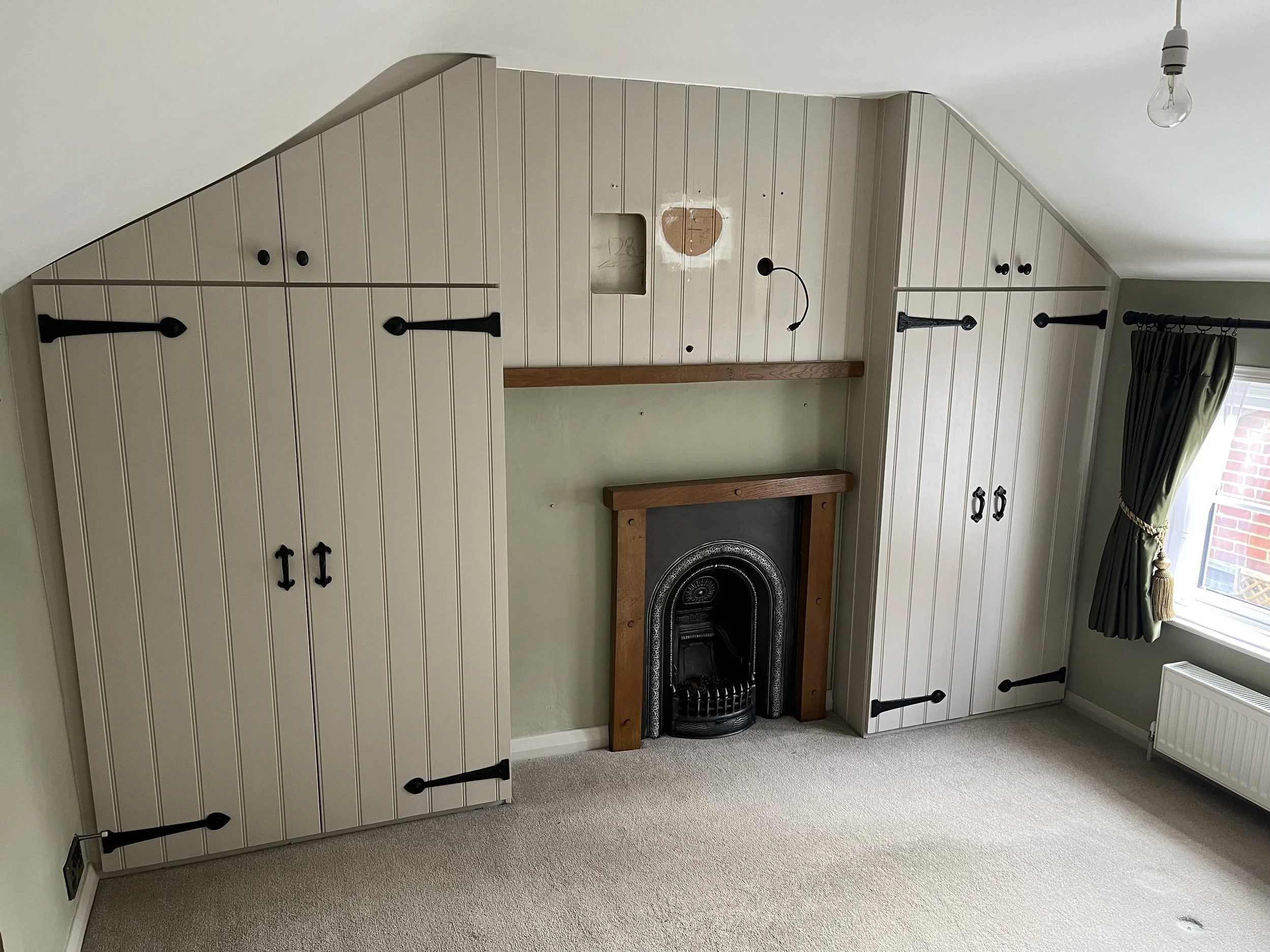 Bespoke - Fitted Wooden Handcrafted and Painted, Scribed Wardrobes with Media Wall.