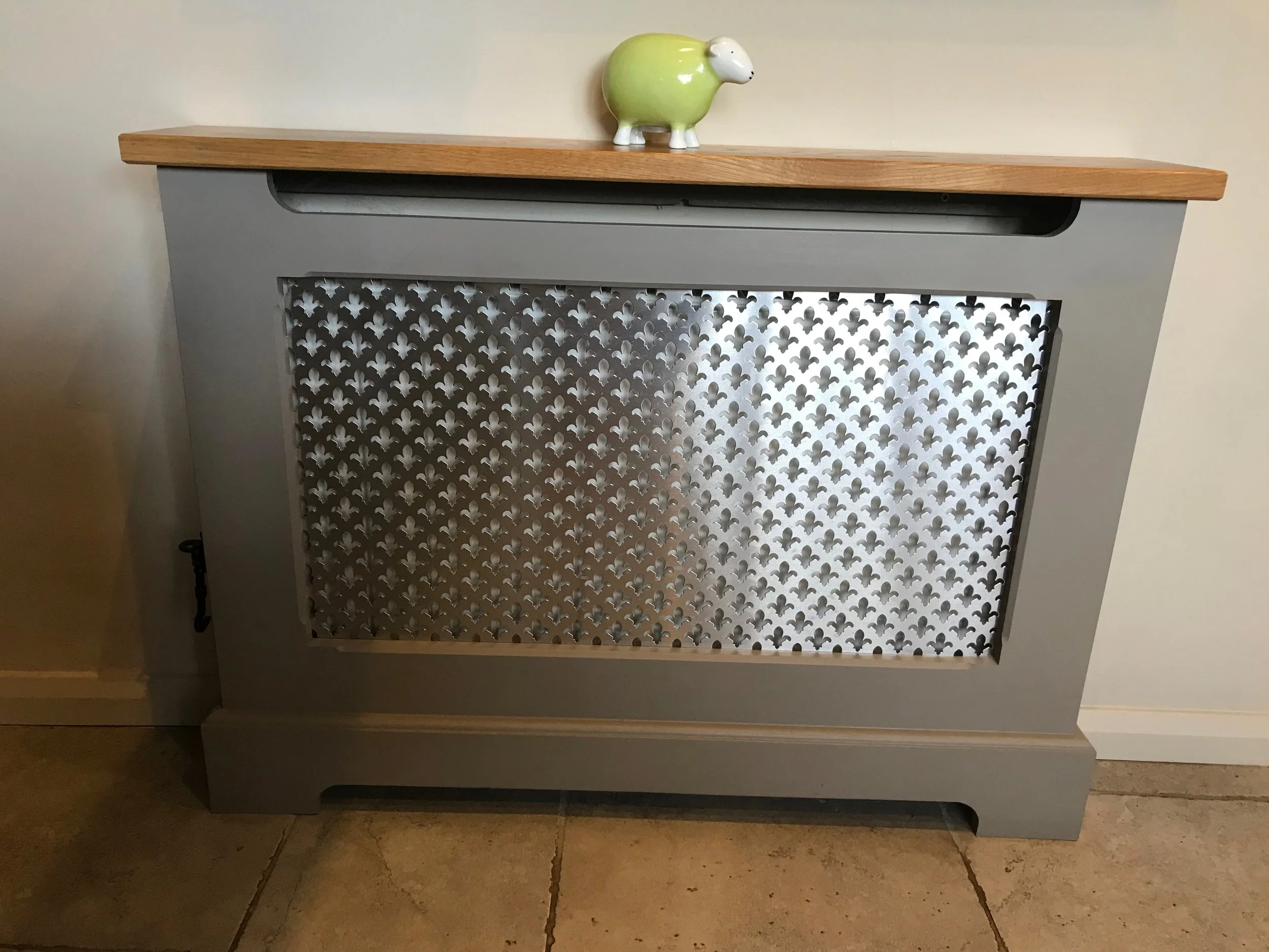 Bespoke radiator cover spray finished to match kitchen units.