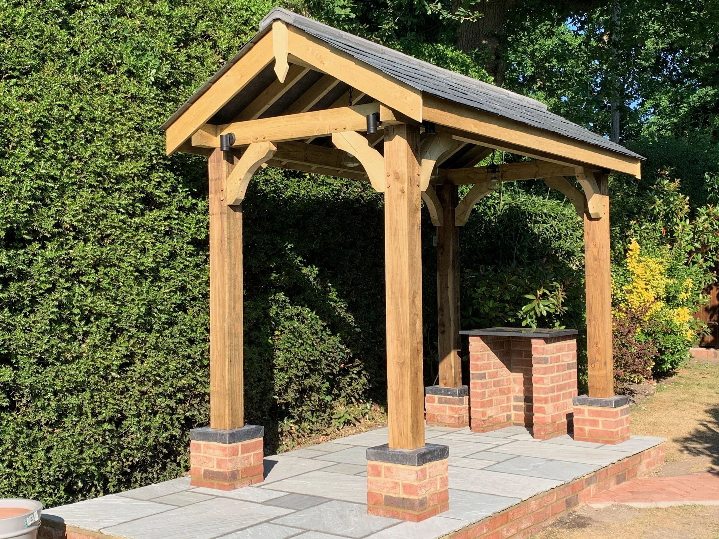 Garden BBQ Kitchen building built from solid timber with slate roof .