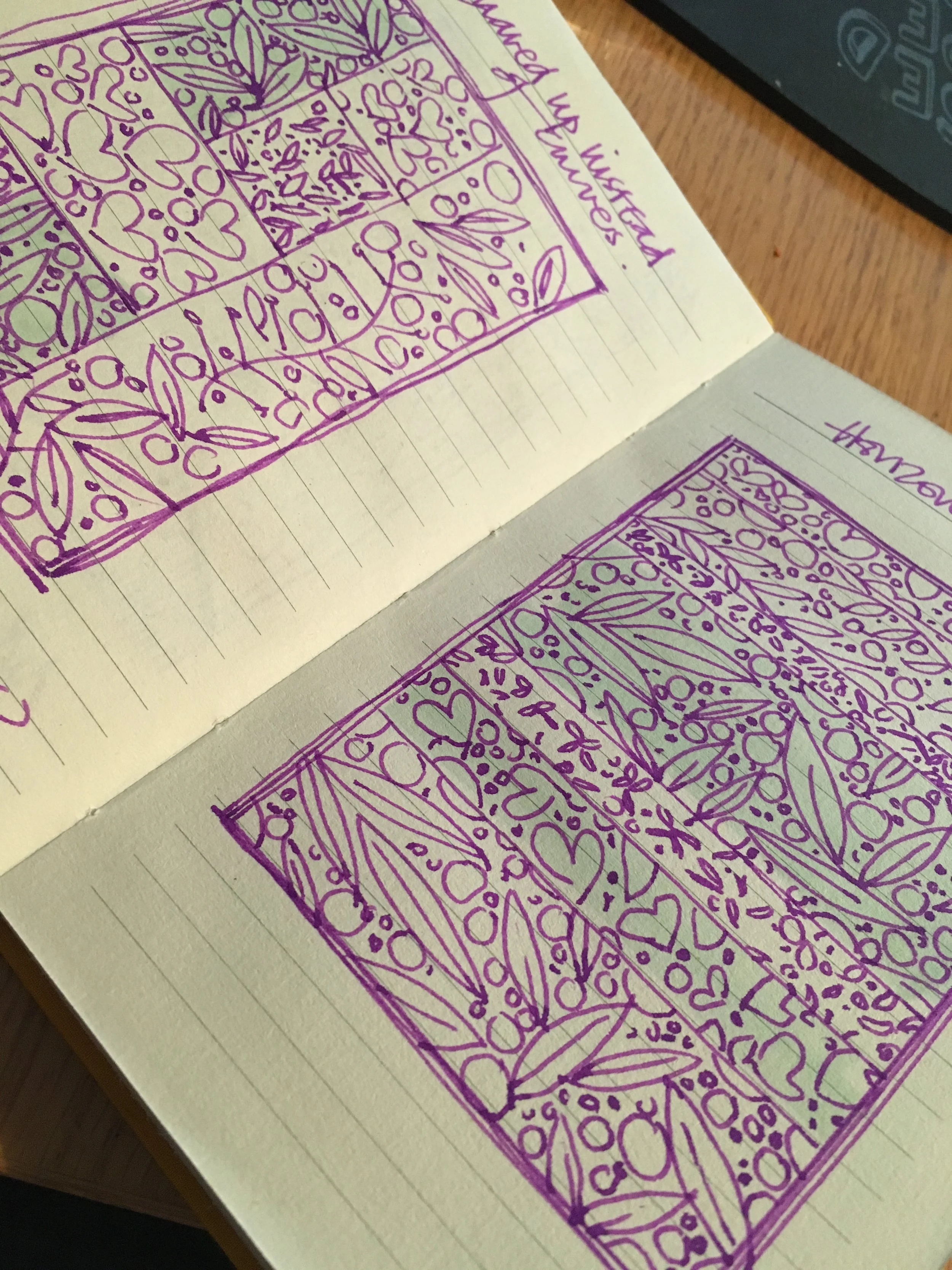 A piece of paper with a detailed purple doodle of a rectangular floral window design, with flowers, leaves, and decorative elements, drawn on lined notebook paper.
