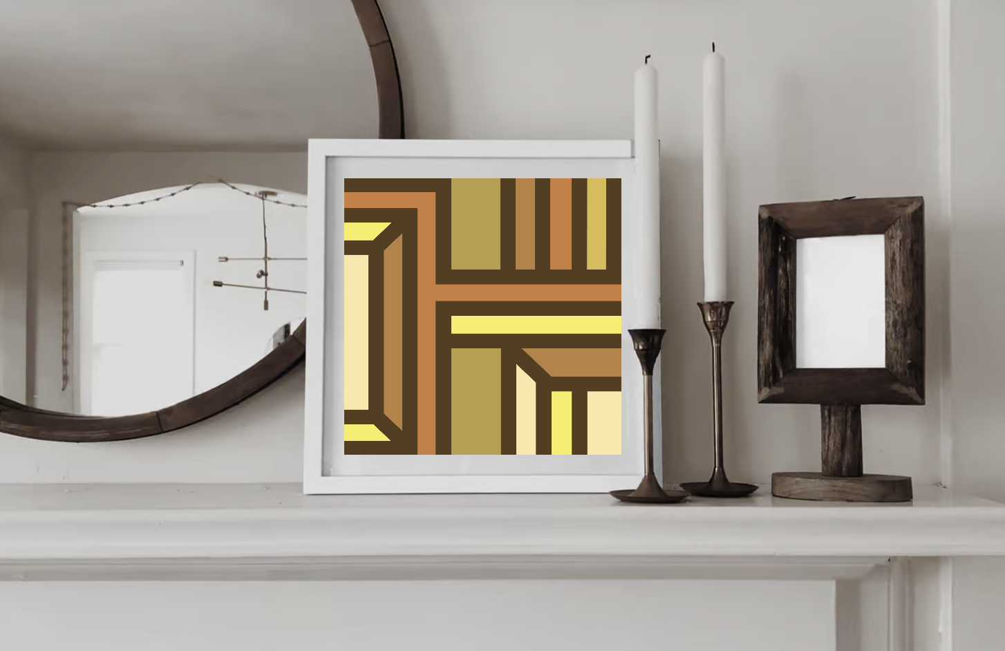 Contemporary geometric art print in cream, yellow and ochre tones displayed in a white wood frame on a shelf in a contemporary interior.