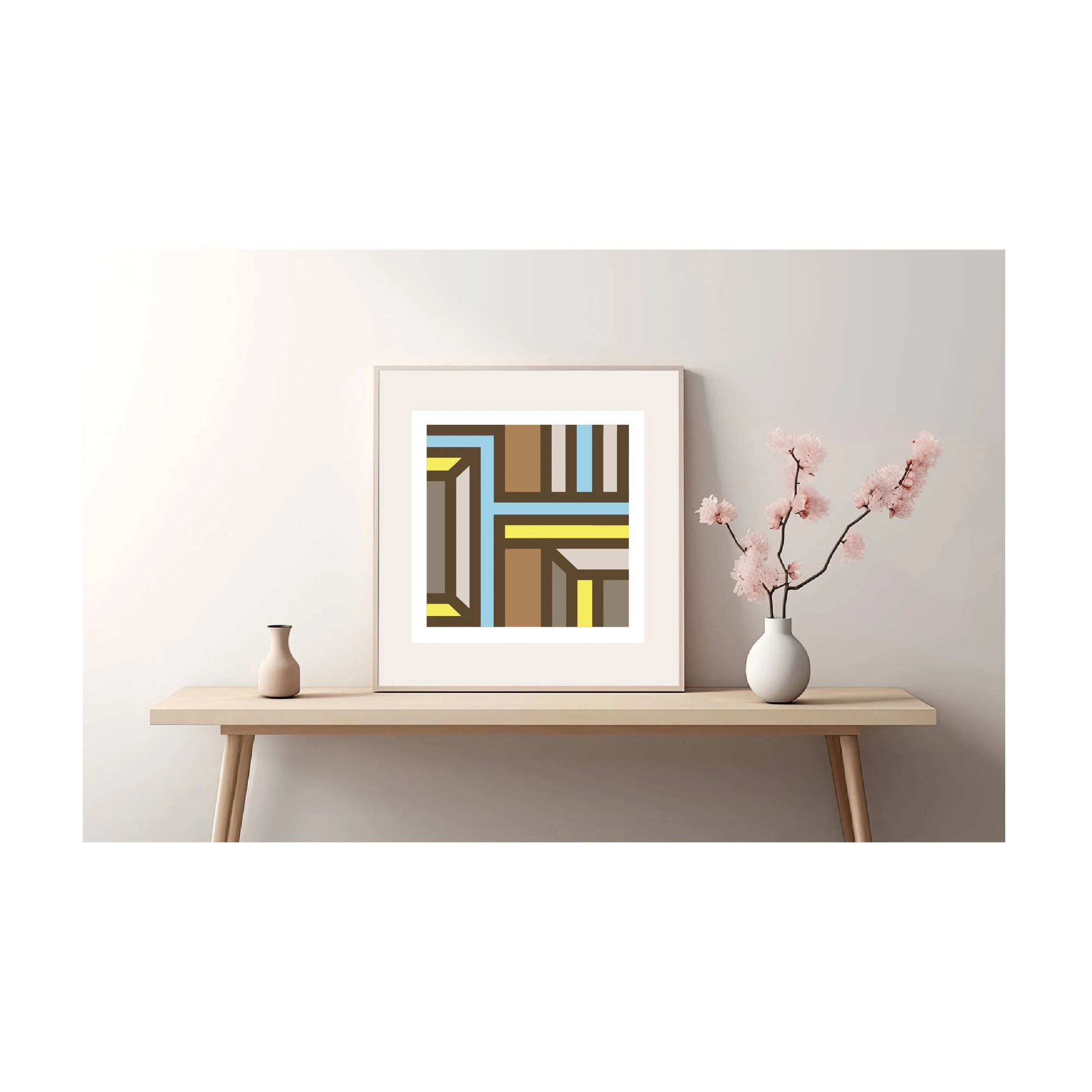 Framed geometric abstract art print displayed on a minimalist wooden console table in a light wood frame in a contemporary interior.