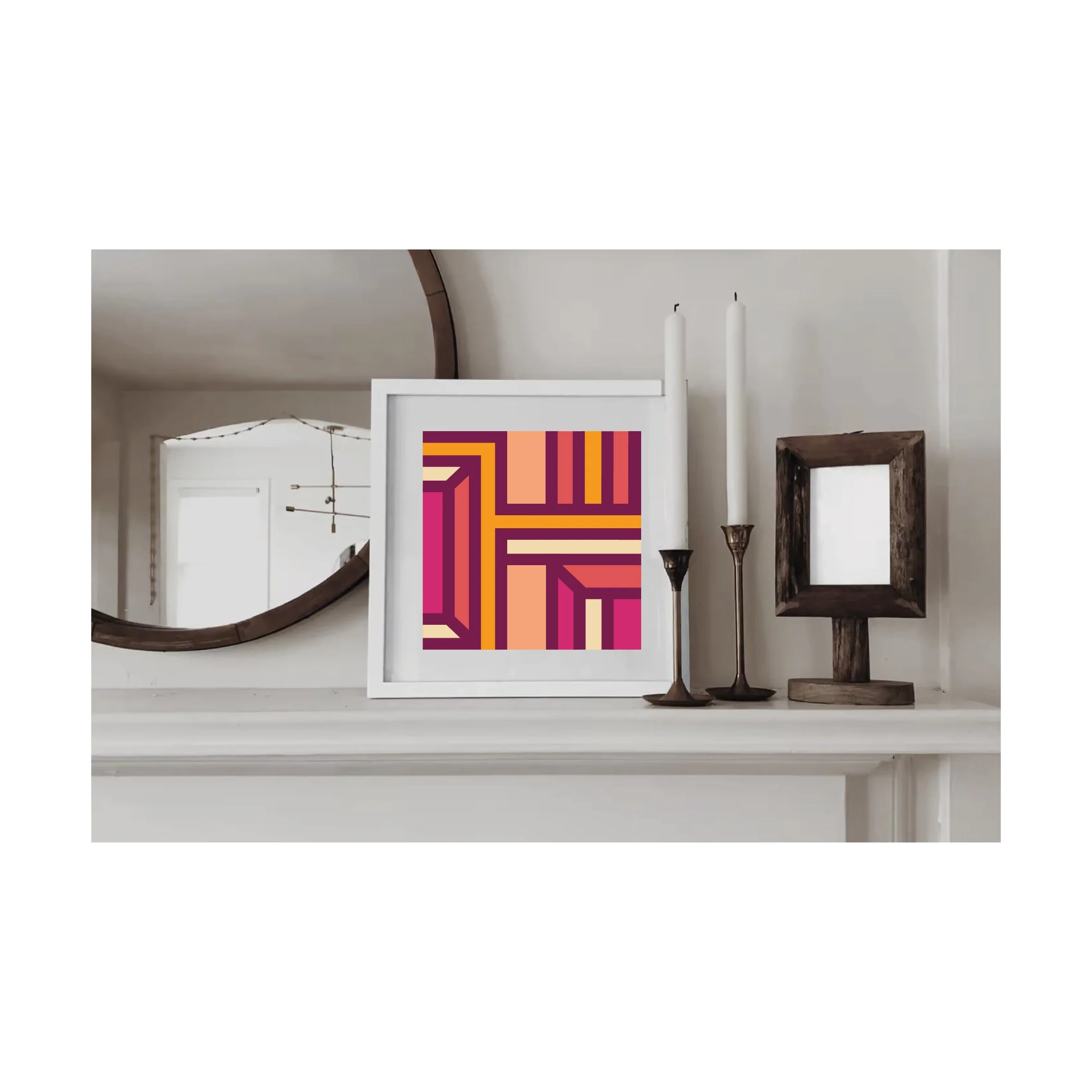 Contemporary geometric art print in pink, orange and burgundy tones  displayed in a white wood frame on a shelf in a contemporary interior.