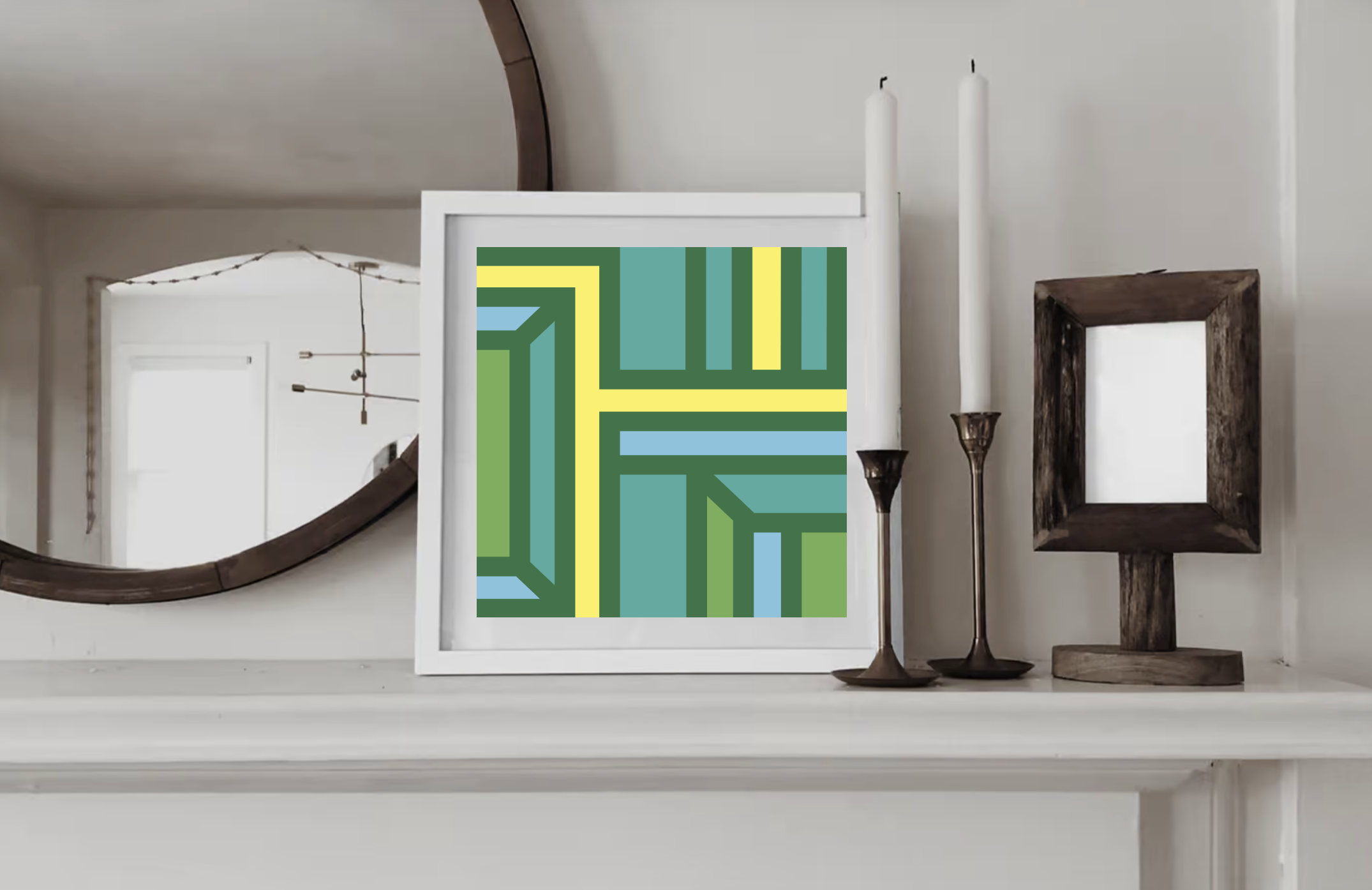 Contemporary geometric art print in green yellow and blue displayed in a white wood frame on a shelf in a contemporary interior.