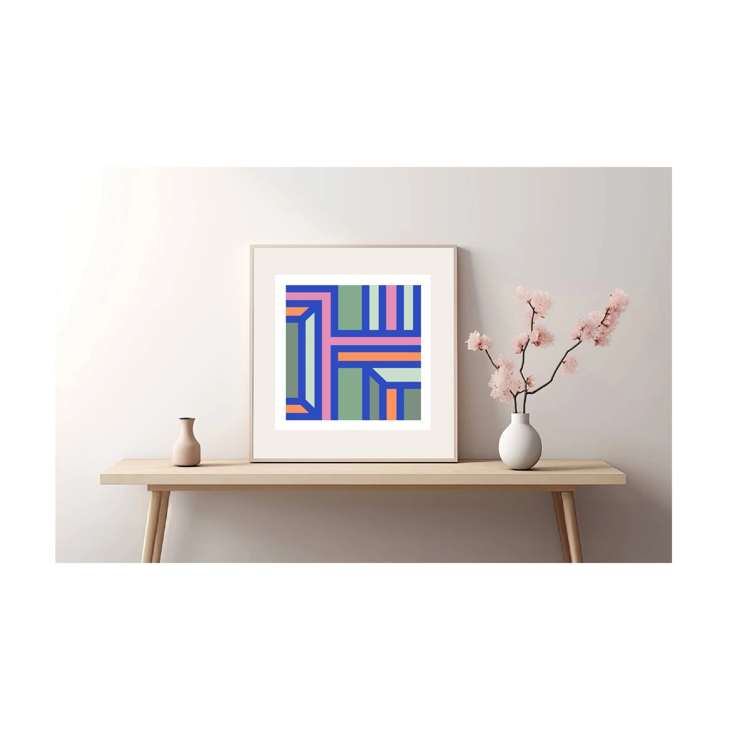 Framed geometric abstract art print displayed on a minimalist wooden console table in a contemporary interior.