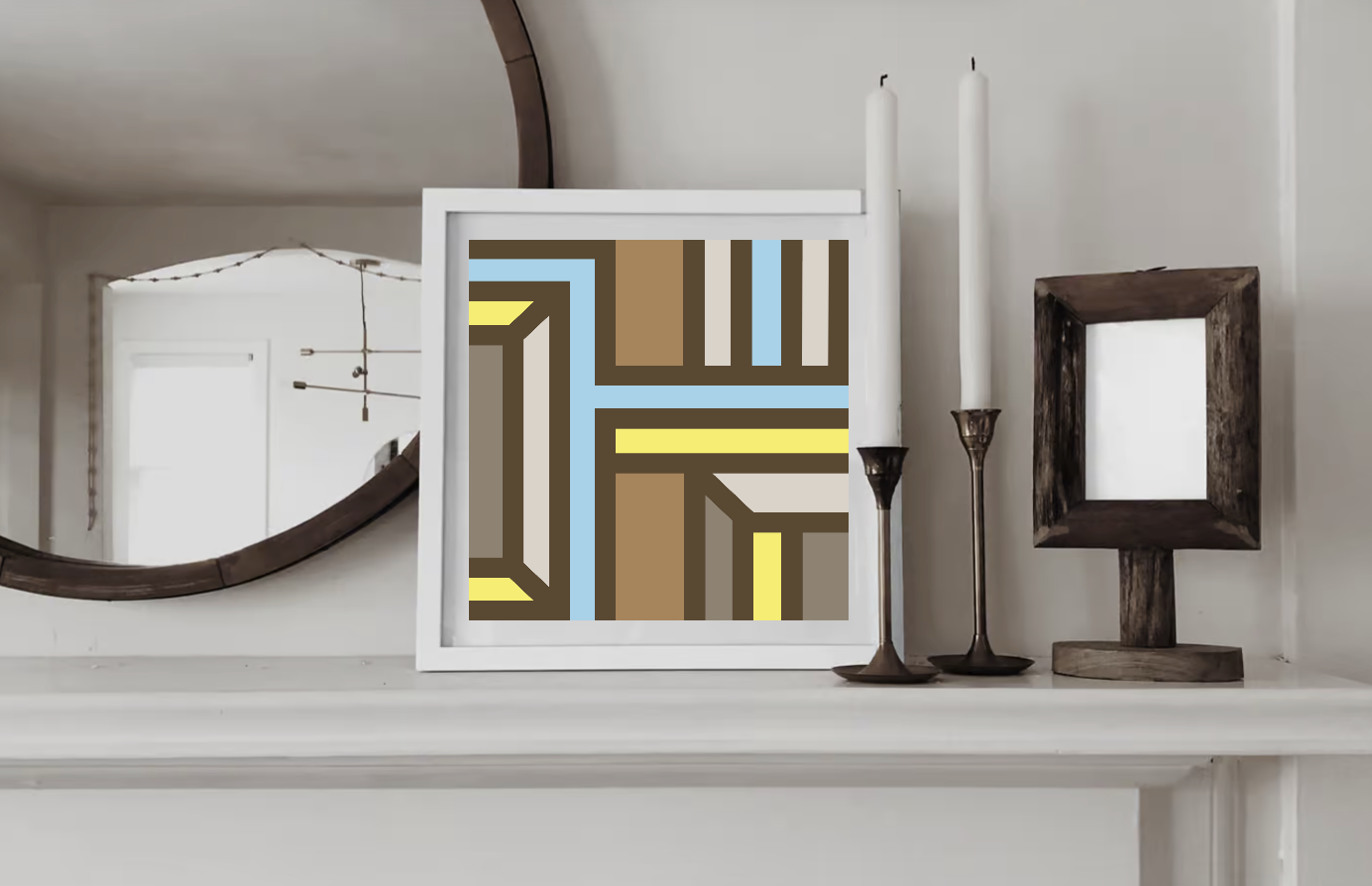 Contemporary geometric art print in brown, yellow, warm grey and light blue tones displayed in a white wood frame on a shelf in a contemporary interior.