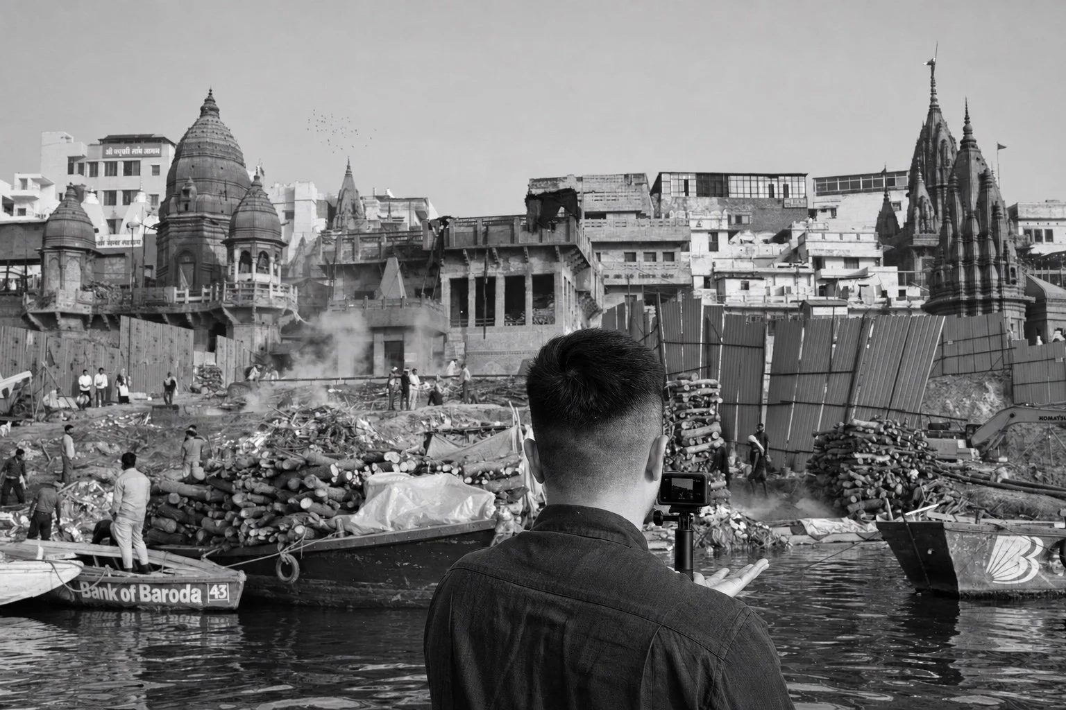 Wepergee filming along the ghats of Varanasi, India, in black and white.