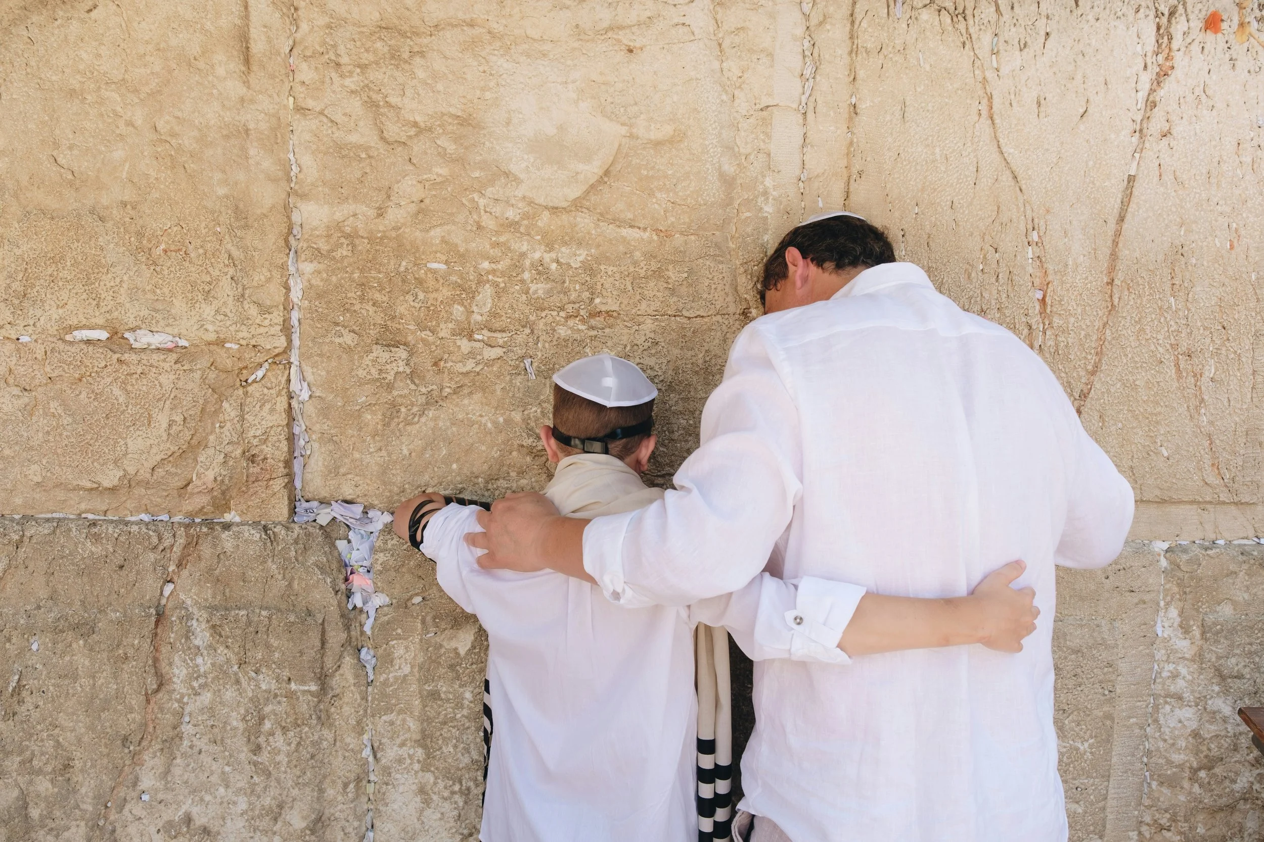 A man and a boy praying at the Western Wall, also known as the Wailing Wall, in Jerusalem.