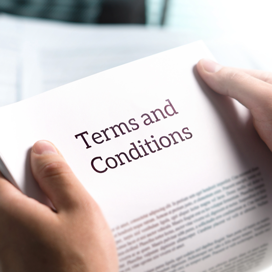 Person holding a document titled 'Terms and Conditions' with blurred text below.
