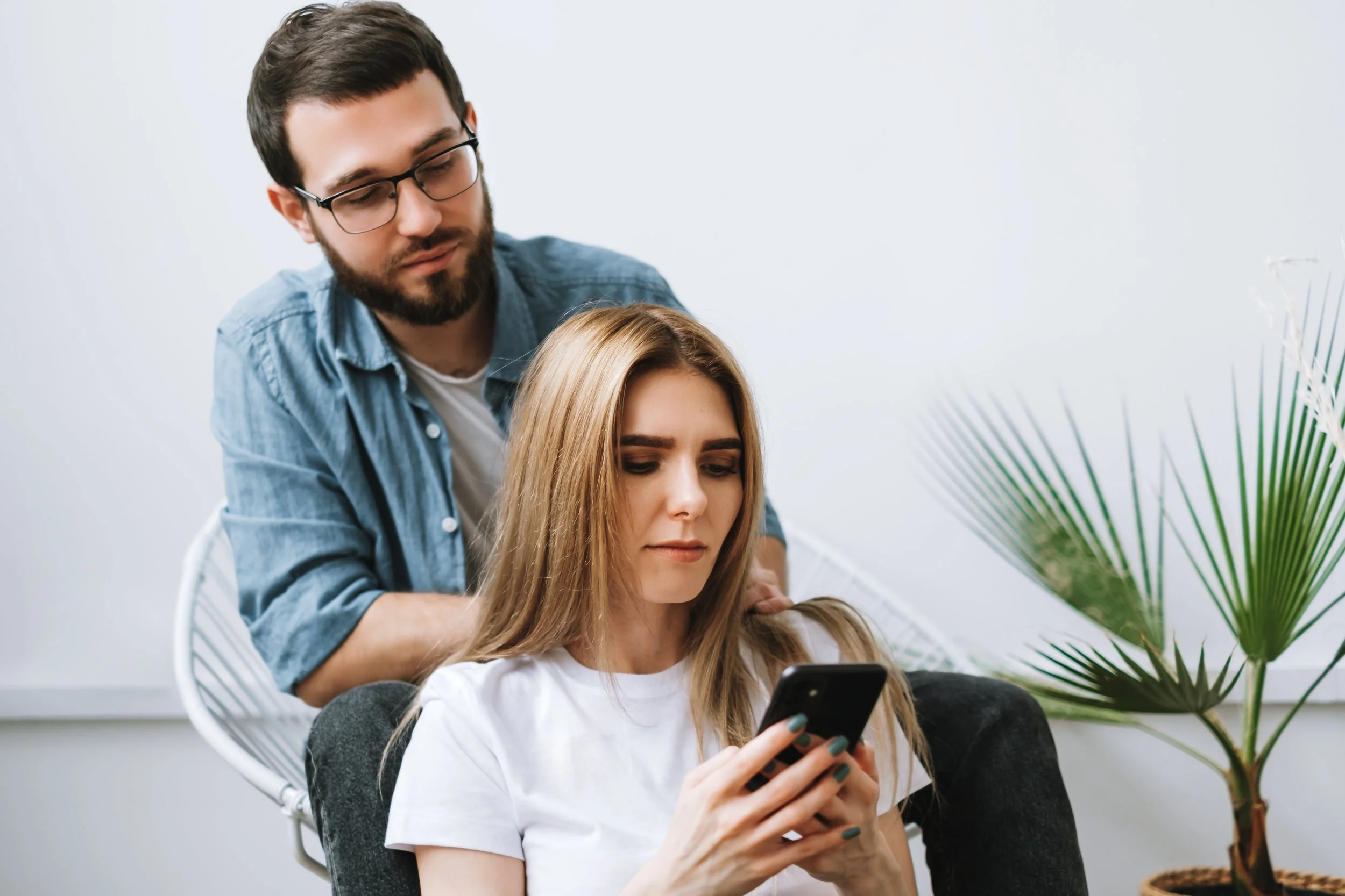 Young couple making an appointment on her cell phone