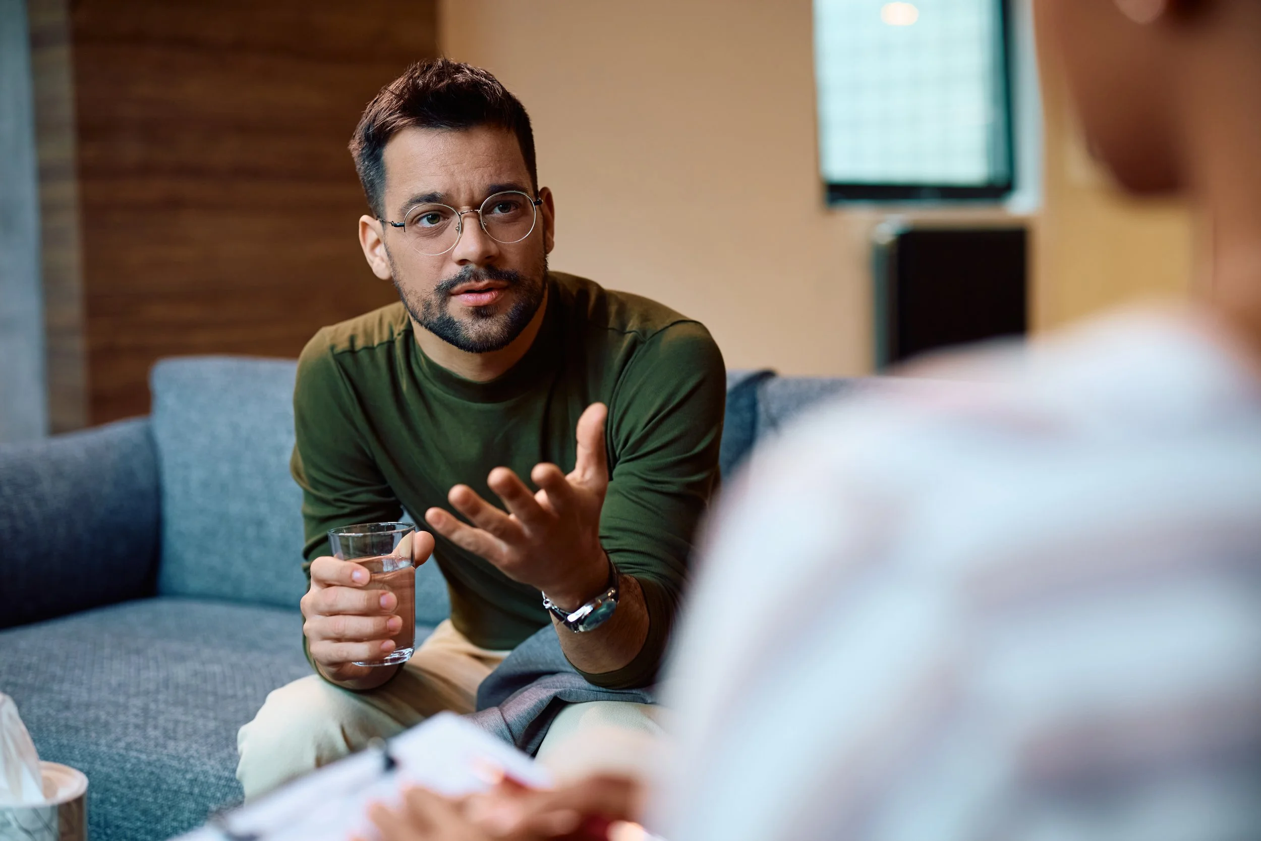 Young man having a counseling session with a mental health professional