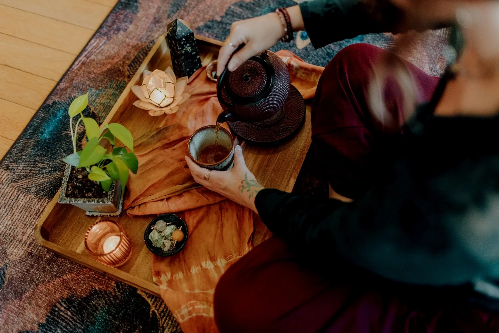 Emily Rose pouring tea from a black teapot during a Parts Integration (IFS) session in Portland