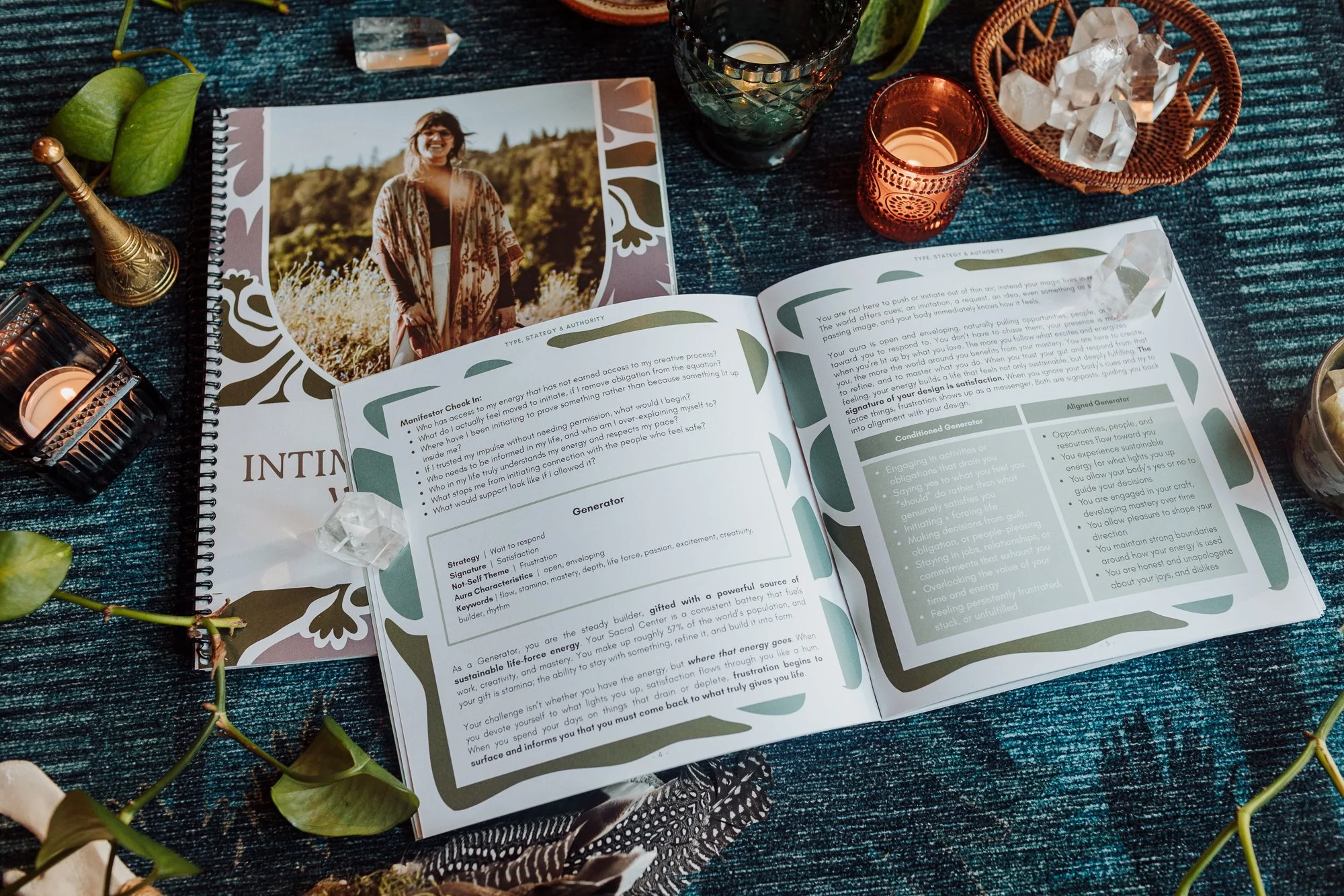 Spiral-bound Intimate Alchemy Workbook for the 6-month 1:1 program with Emily Rose Meredith, on Human Design Type, Strategy and Authority pages surrounded by quartz crystals and a brass bell