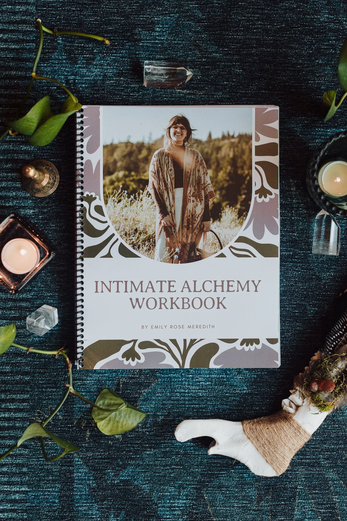Vertical flat lay of the Intimate Alchemy Workbook, a somatic healing and Human Design workbook by Emily Rose Meredith
