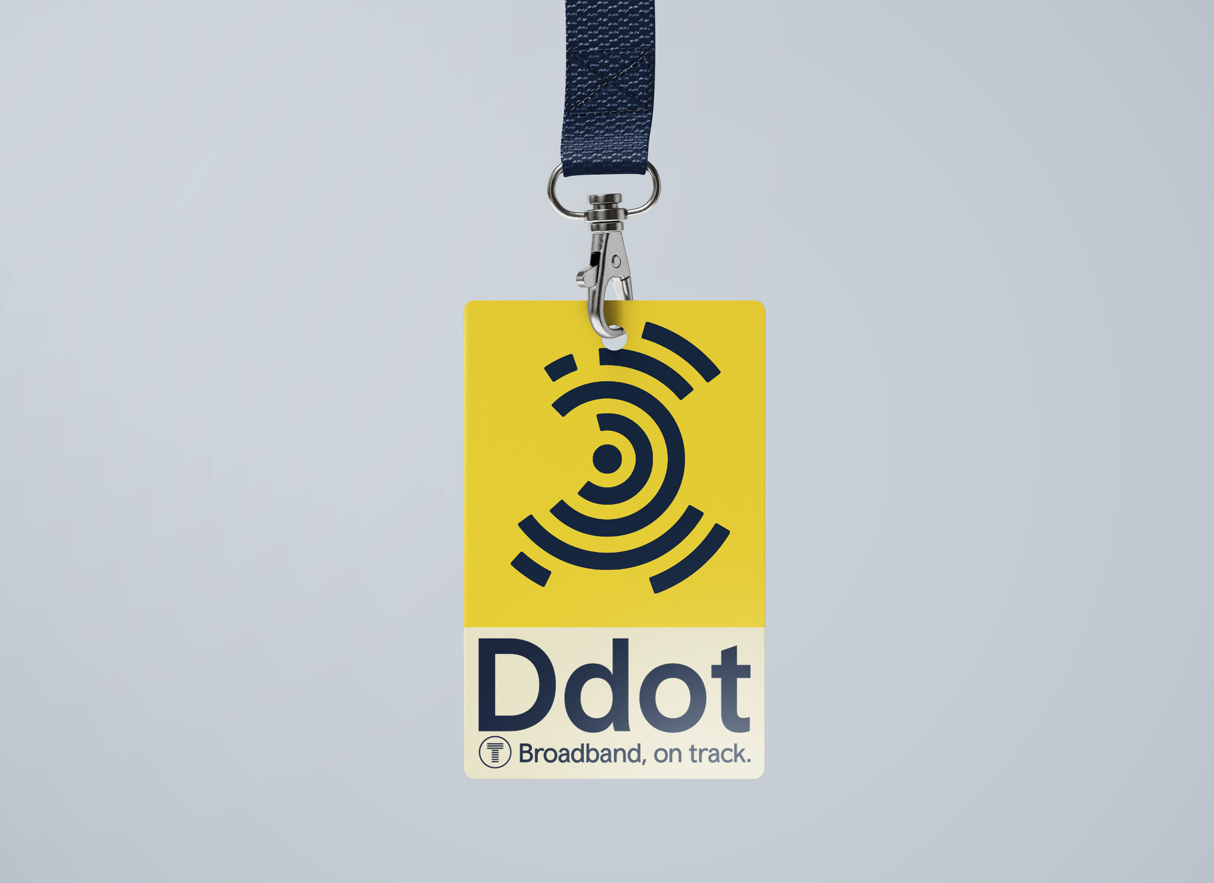 Close-up of a yellow badge with a Wi-Fi signal icon and the word 'Dot' printed on it. The badge is attached to a blue lanyard with a metal clip and is labeled ‘Broadband, on track’ at the bottom.