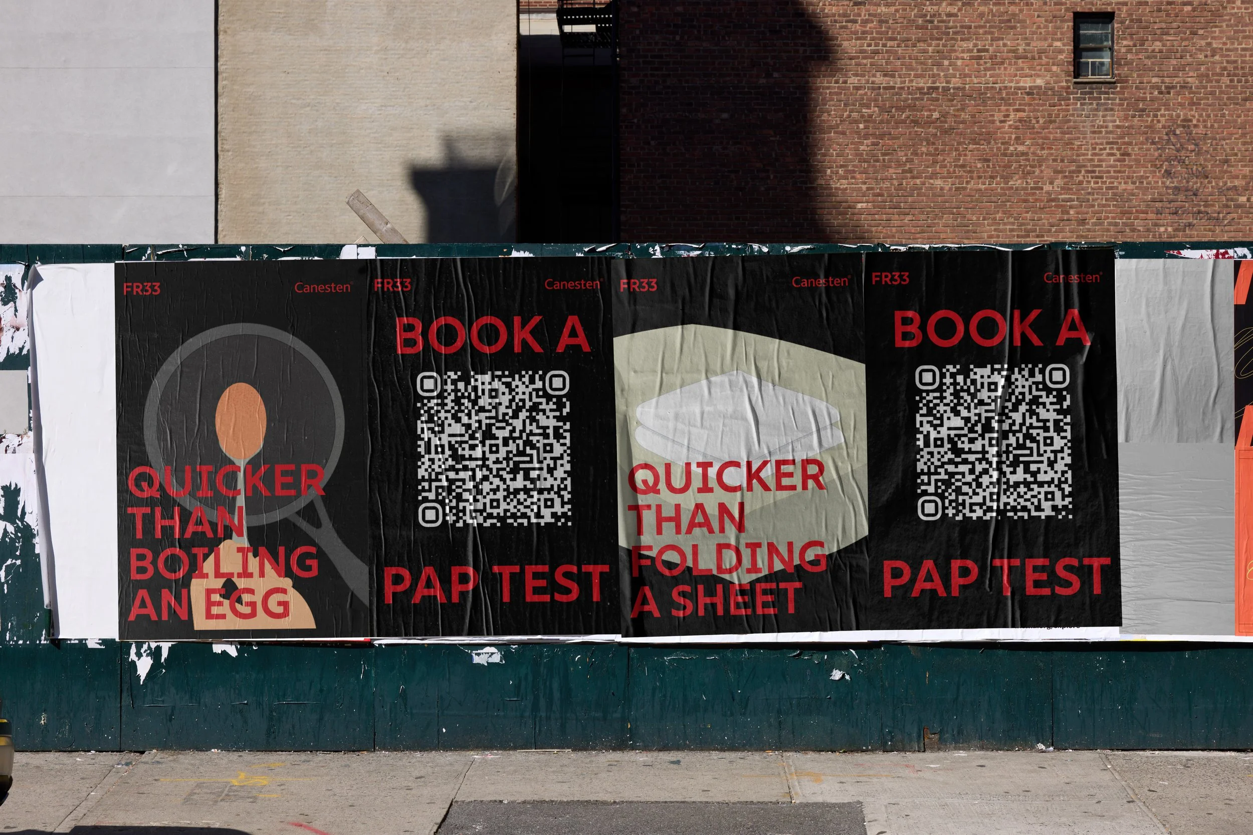 Street scene with a black banner advertising book testing and egg boiling, featuring QR codes, hanging against a green wall with peeling paint. In the background are brick and concrete buildings.