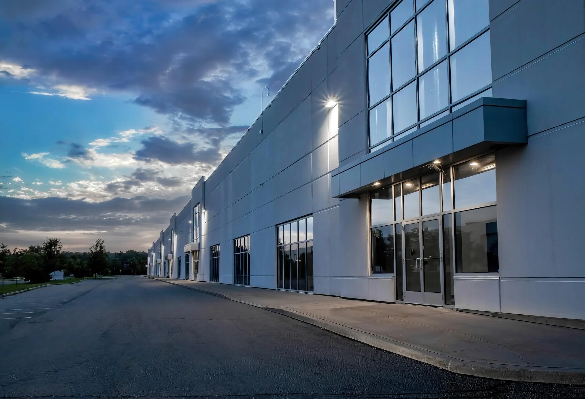 Modern white commercial building with large glass windows