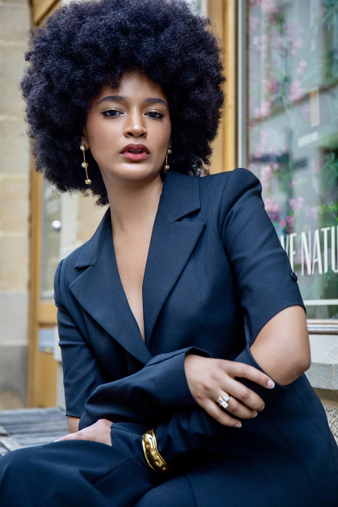 Fashion editorial portrait of model Ana wearing a sophisticated navy blue tailored outfit by Francini_K, complemented by elegant Ennomerato jewelry. Photographed in Luxembourg by Henri Da Cruz, combining contemporary fashion, refined styling and urba