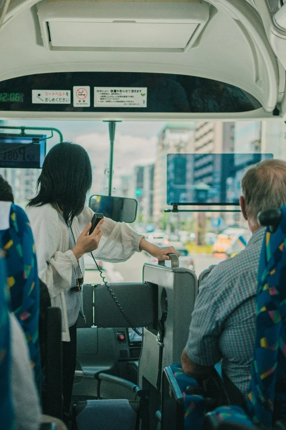 A personal care worker assisting an elderly passenger on a bus, highlighting safe and reliable travel and transport assistance services in Victoria.