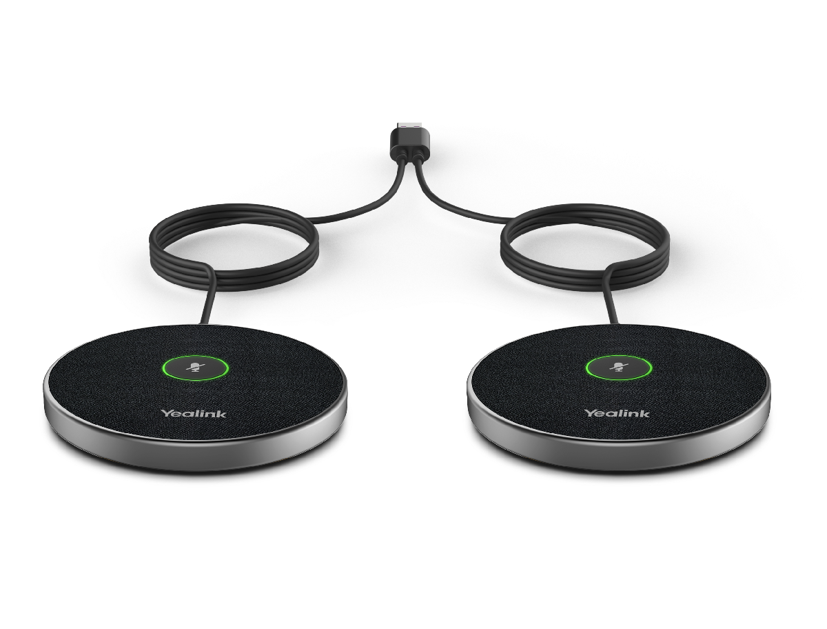 Two wireless conference microphones connected to a central control unit, placed on a white surface.