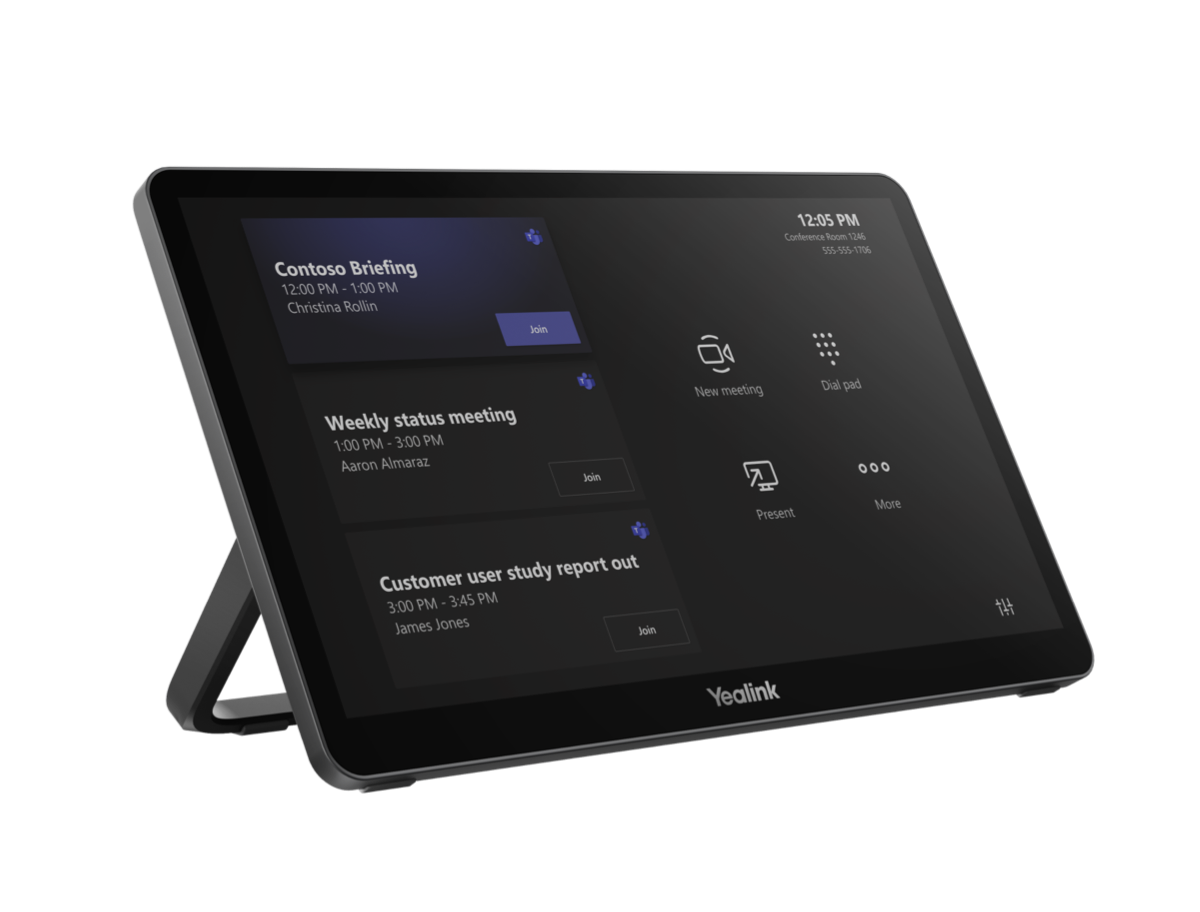 A black digital conference room scheduling tablet with a screen showing scheduled meetings, options for creating or joining meetings, and the time 12:05 PM.