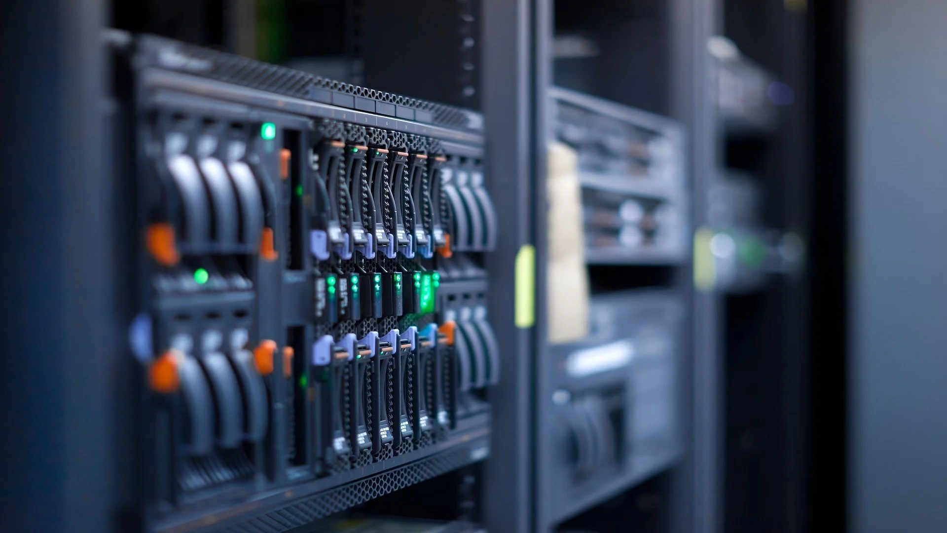 Close-up of a server rack inside a data center, showing multiple illuminated network switches and cables.