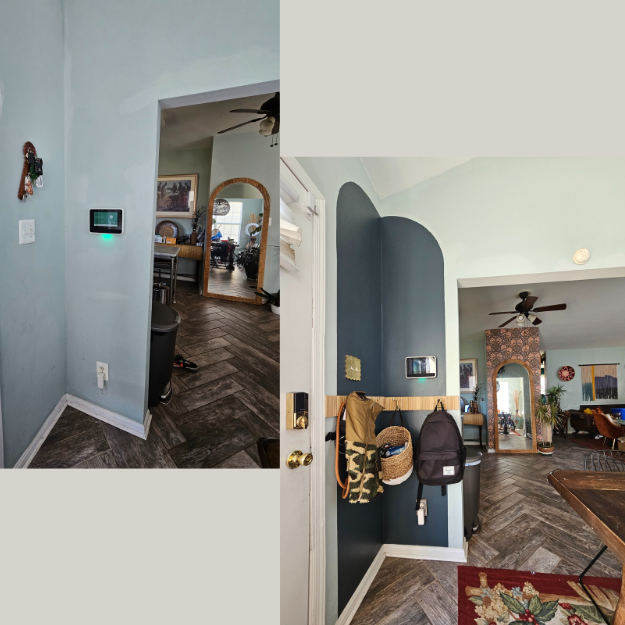 View of a home interior showing an entryway with hooks and backpacks, leading to a living room with dark wood flooring, a ceiling fan, artwork, and an arched door.