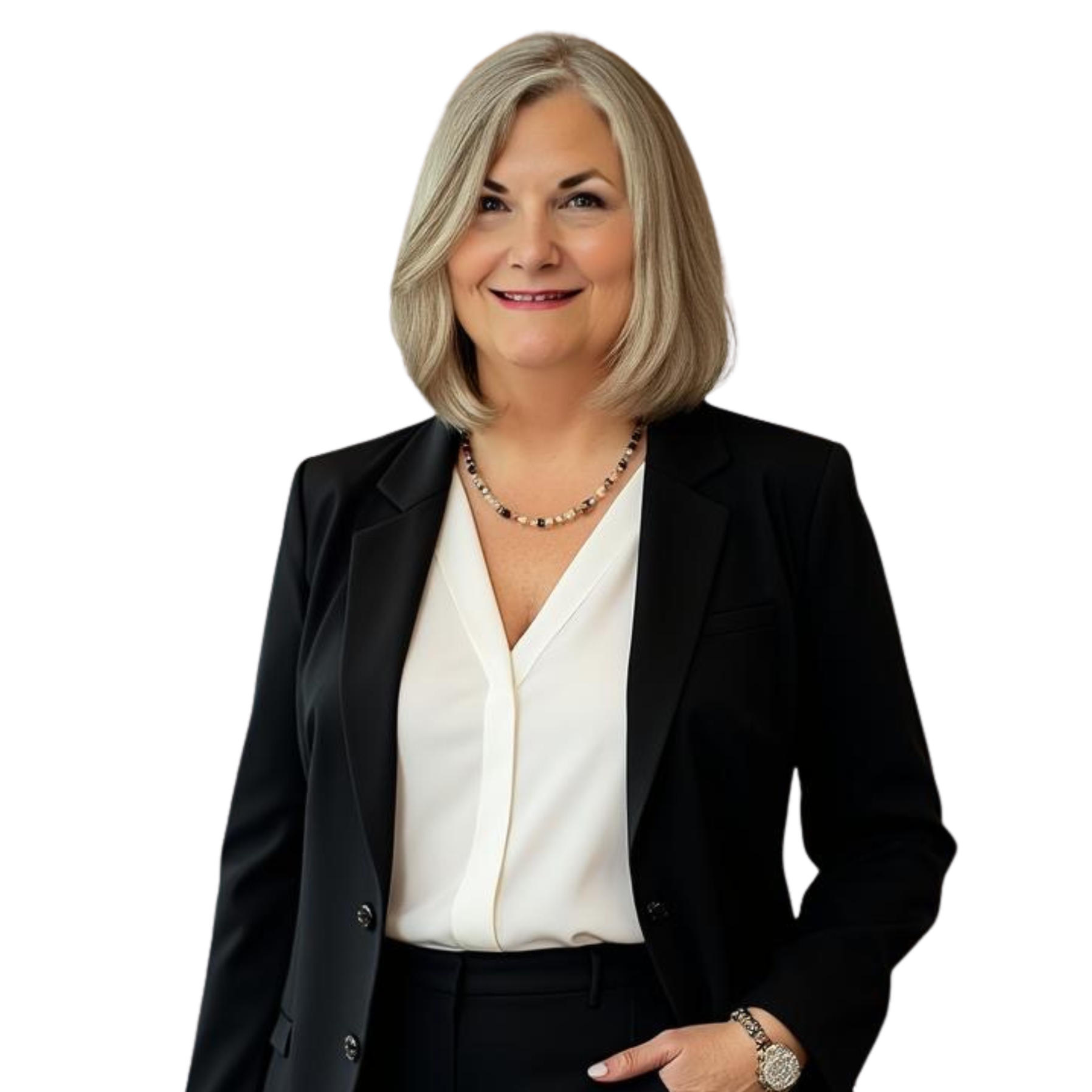 A woman with shoulder-length blonde hair smiling, wearing a black blazer over a white blouse, accessorized with a beaded necklace and a watch, against a black background.