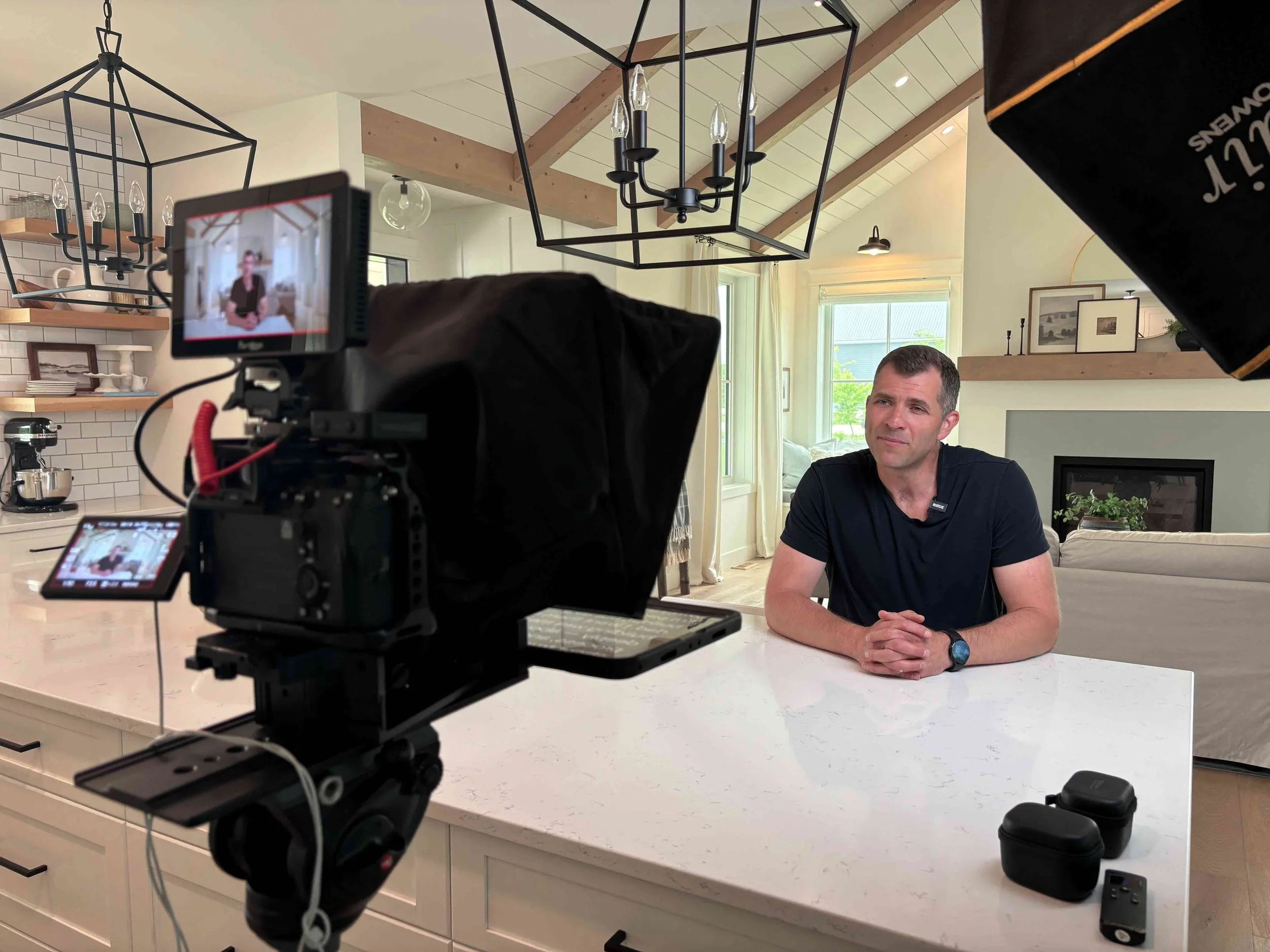 Winnipeg videographer filming client testimonial video for Oaken Builders with professional video production setup.