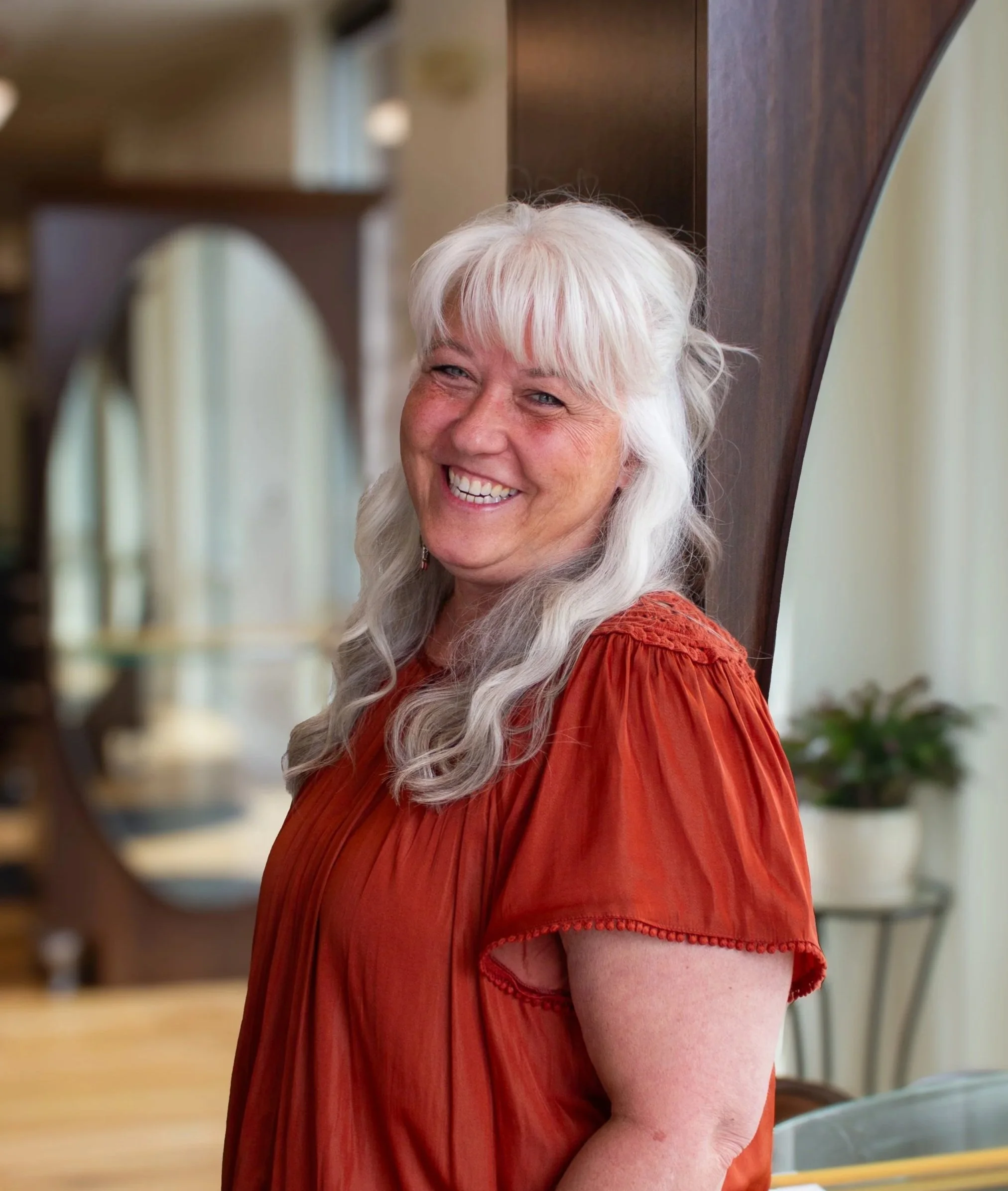 Christie, hair stylist at Prestige Salon in Wayne, PA, headshot in the salon.