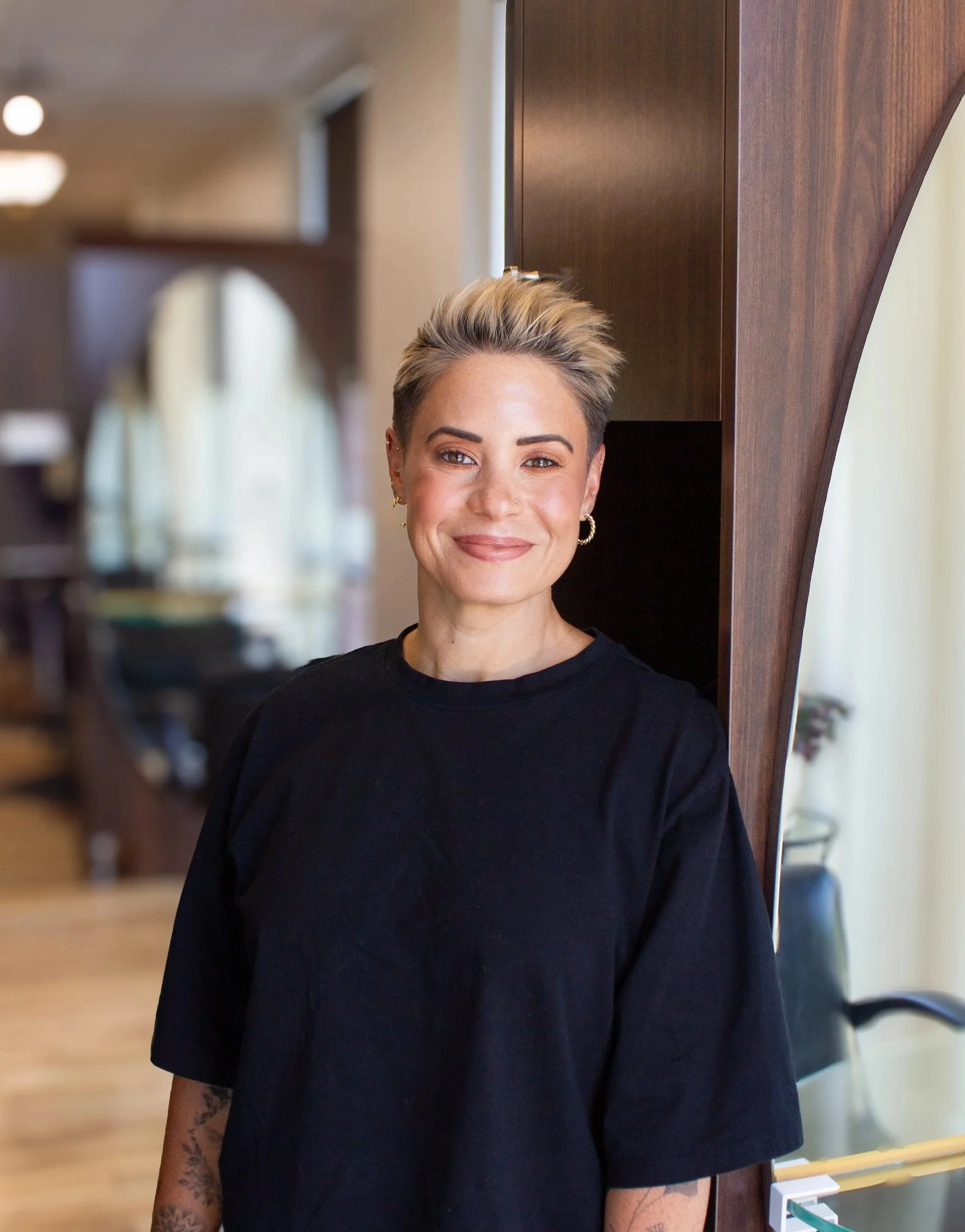 Erica, hair stylist at Prestige Salon in Wayne, PA, headshot in the salon.