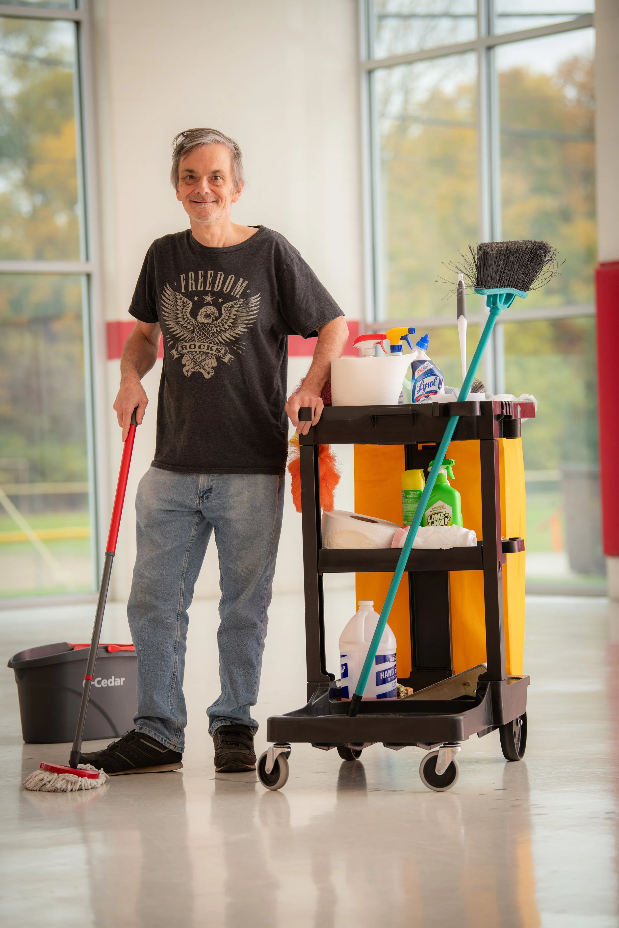 An Enact Career Connections participant in his workplace, performing janitorial duties.